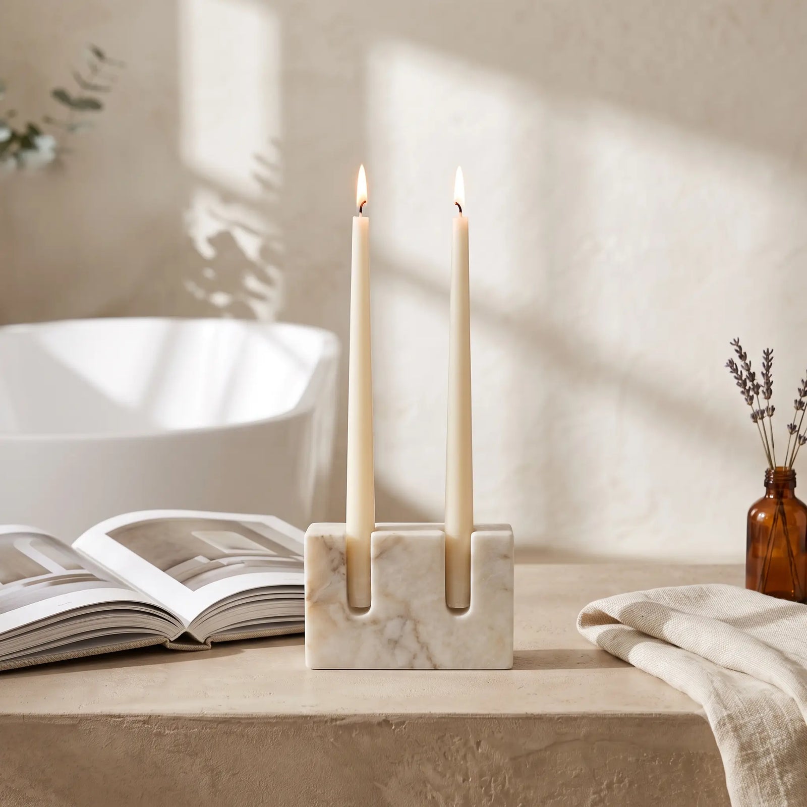Double Slot Candle Holder in White Marble styled in a bathroom with lit taper candles — Verdora