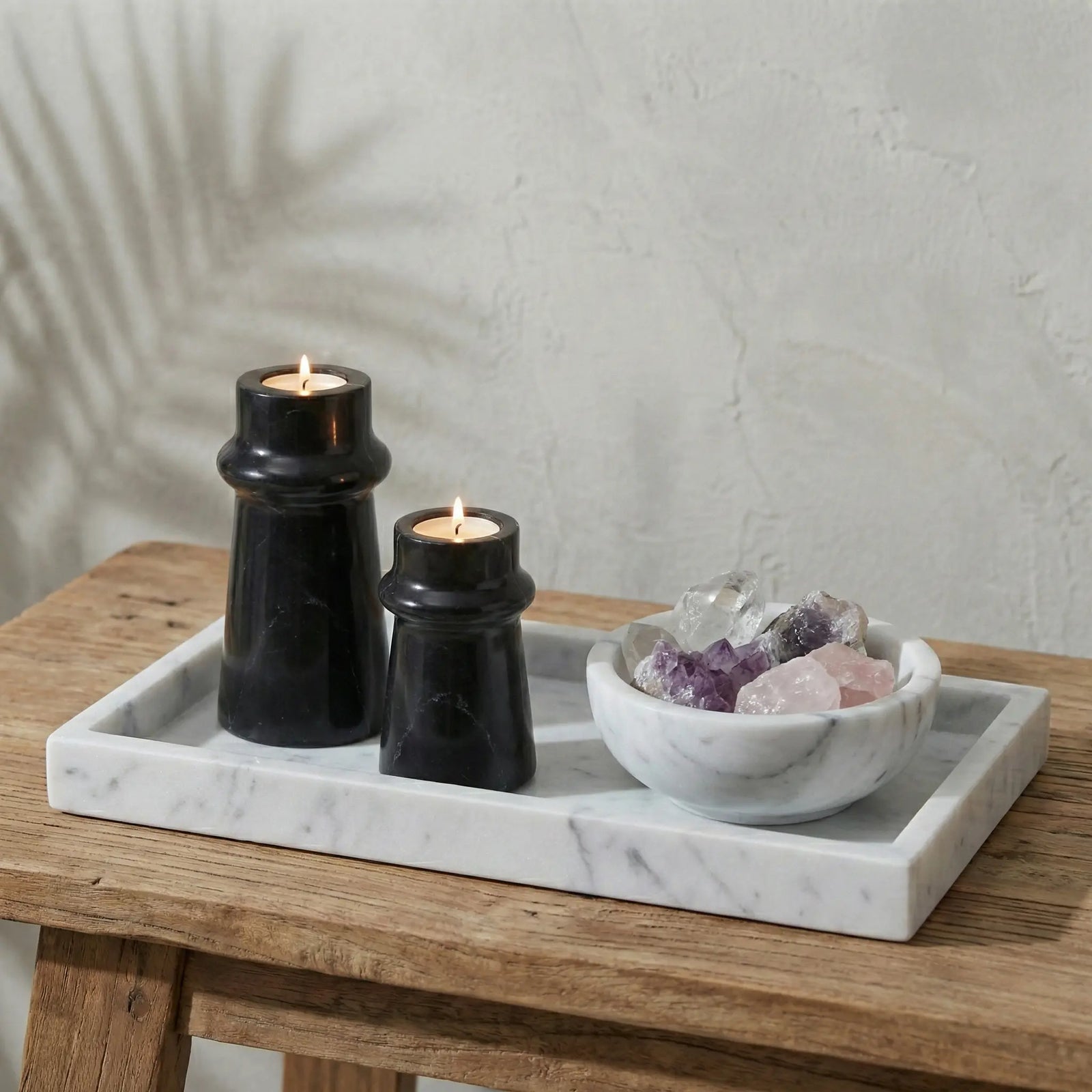 Black Marble Taper Holders displayed on a white marble tray with crystals in a lifestyle setting