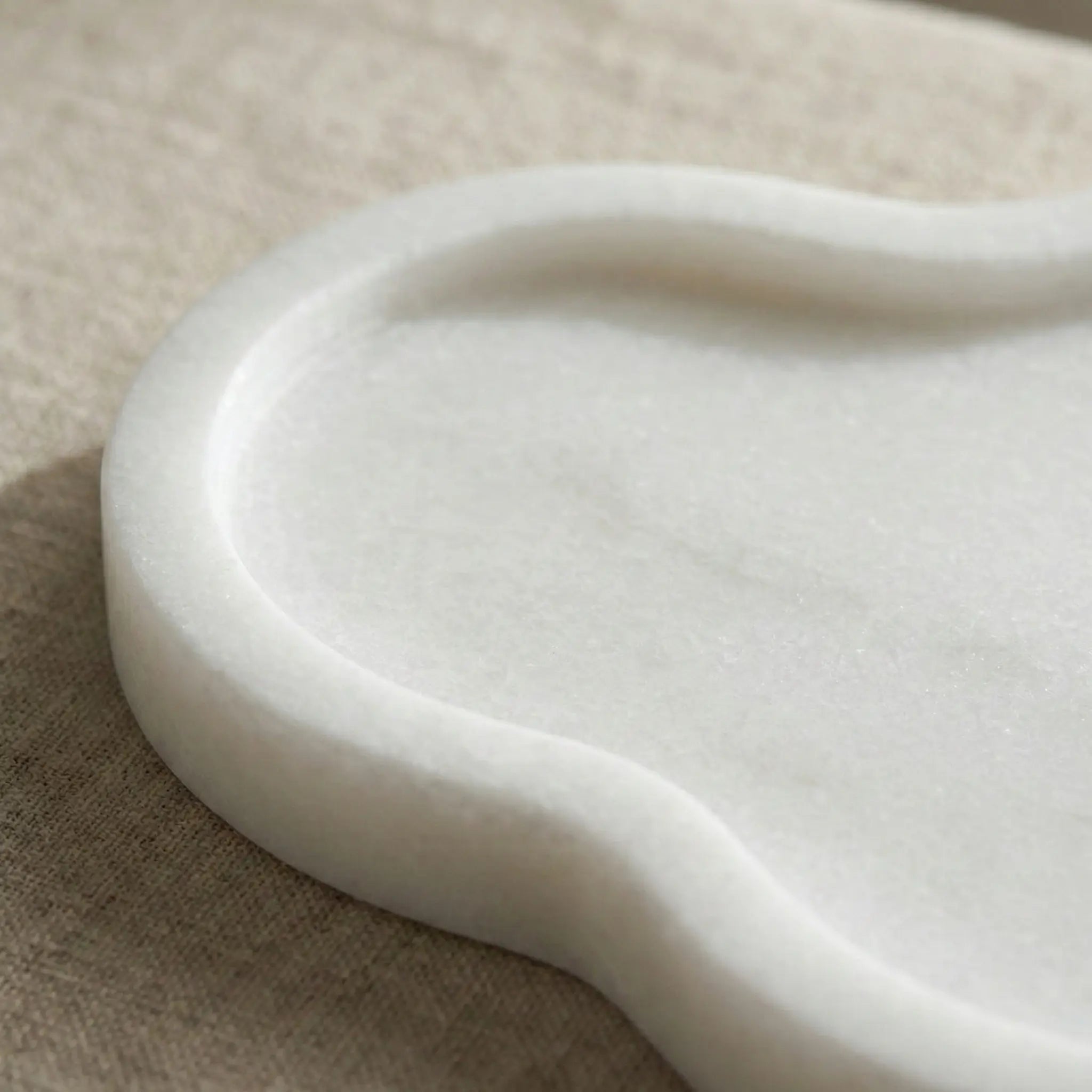 Close-up of Calacatta White Cloud Tray showing the smooth curved edge and subtle grey veining of the natural marble.