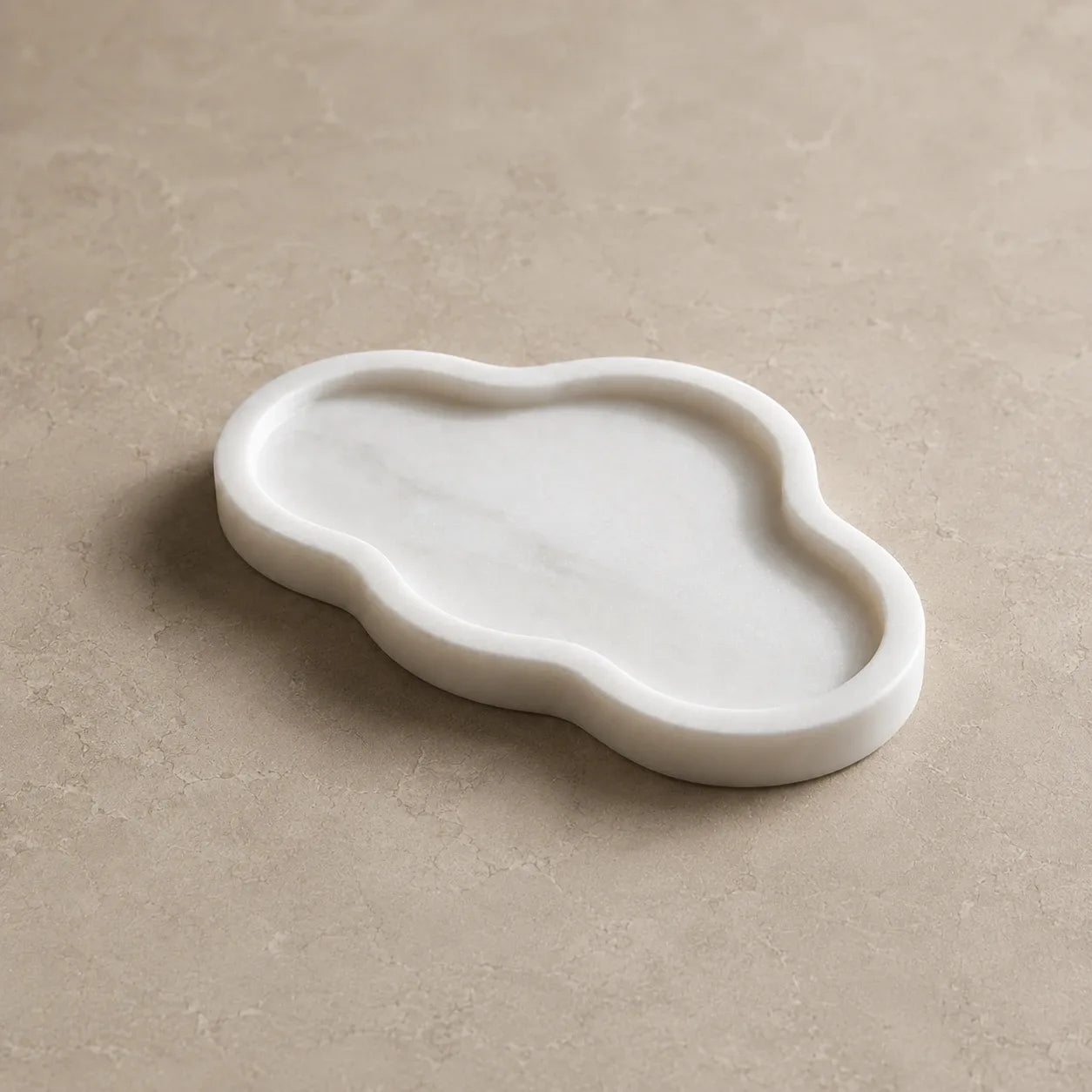 White marble cloud-shaped tray with organic wavy edge and recessed interior
