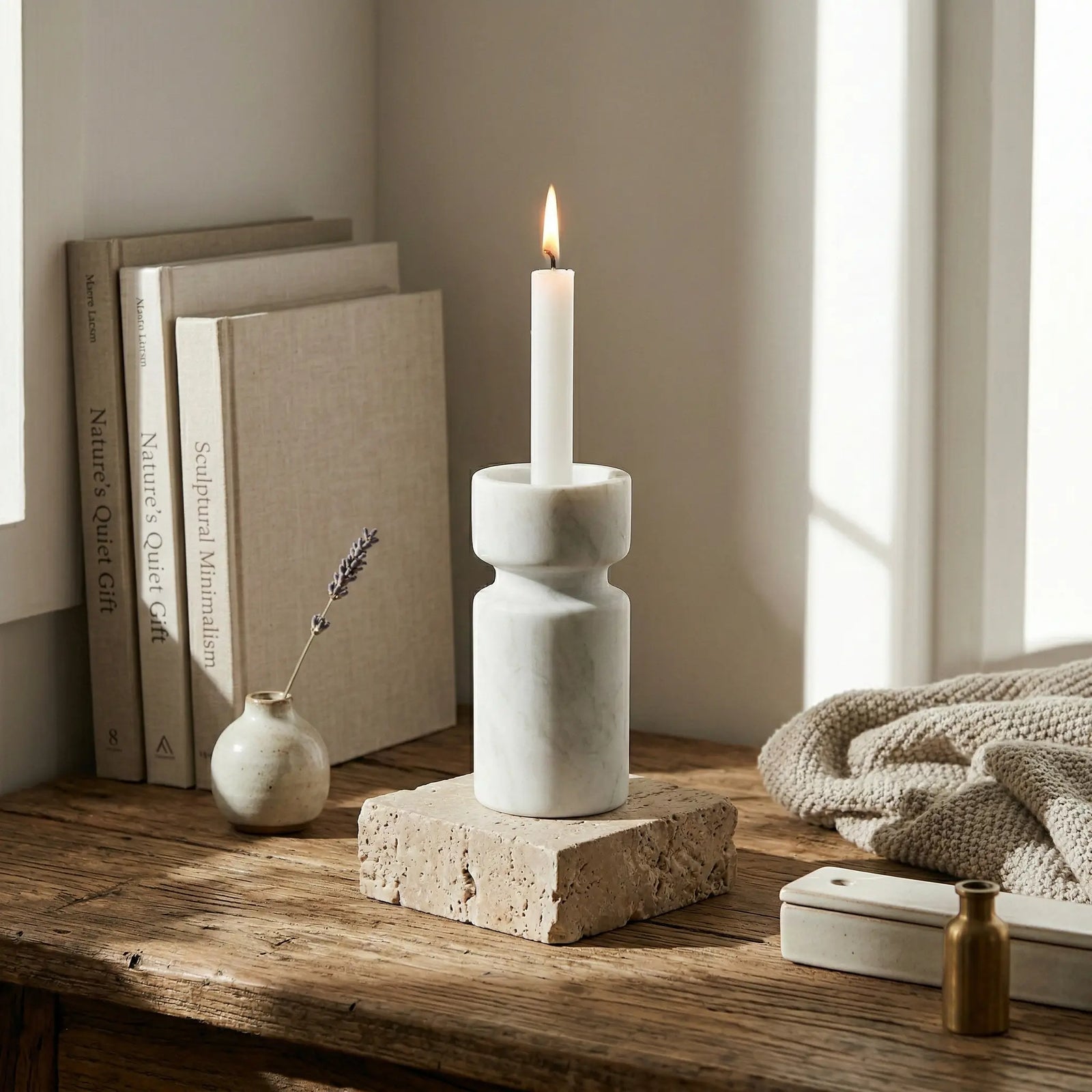 White marble Cylindrical Monolith Pillar used as a taper candle holder on a rustic wooden table