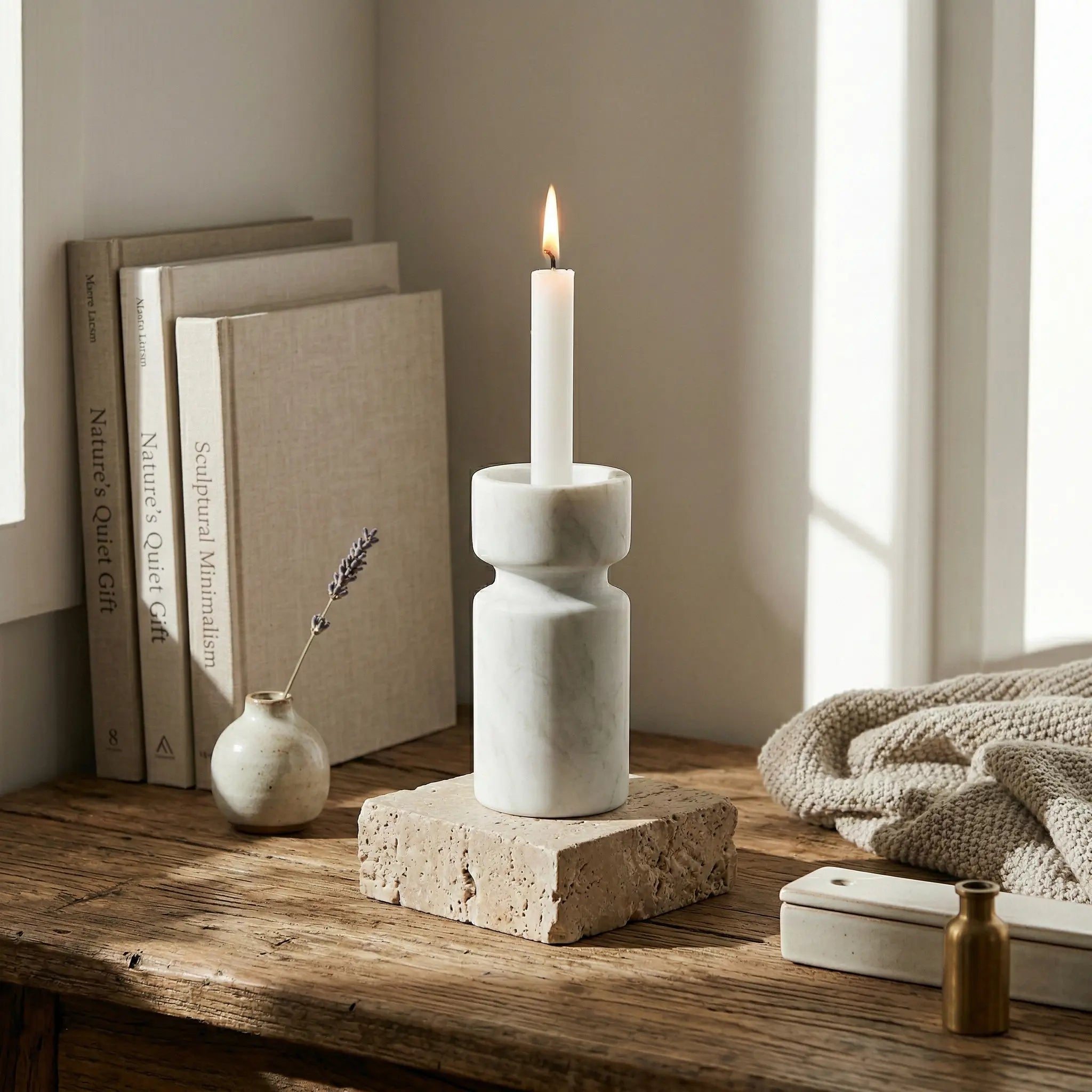 White marble Cylindrical Monolith Pillar used as a taper candle holder on a rustic wooden table