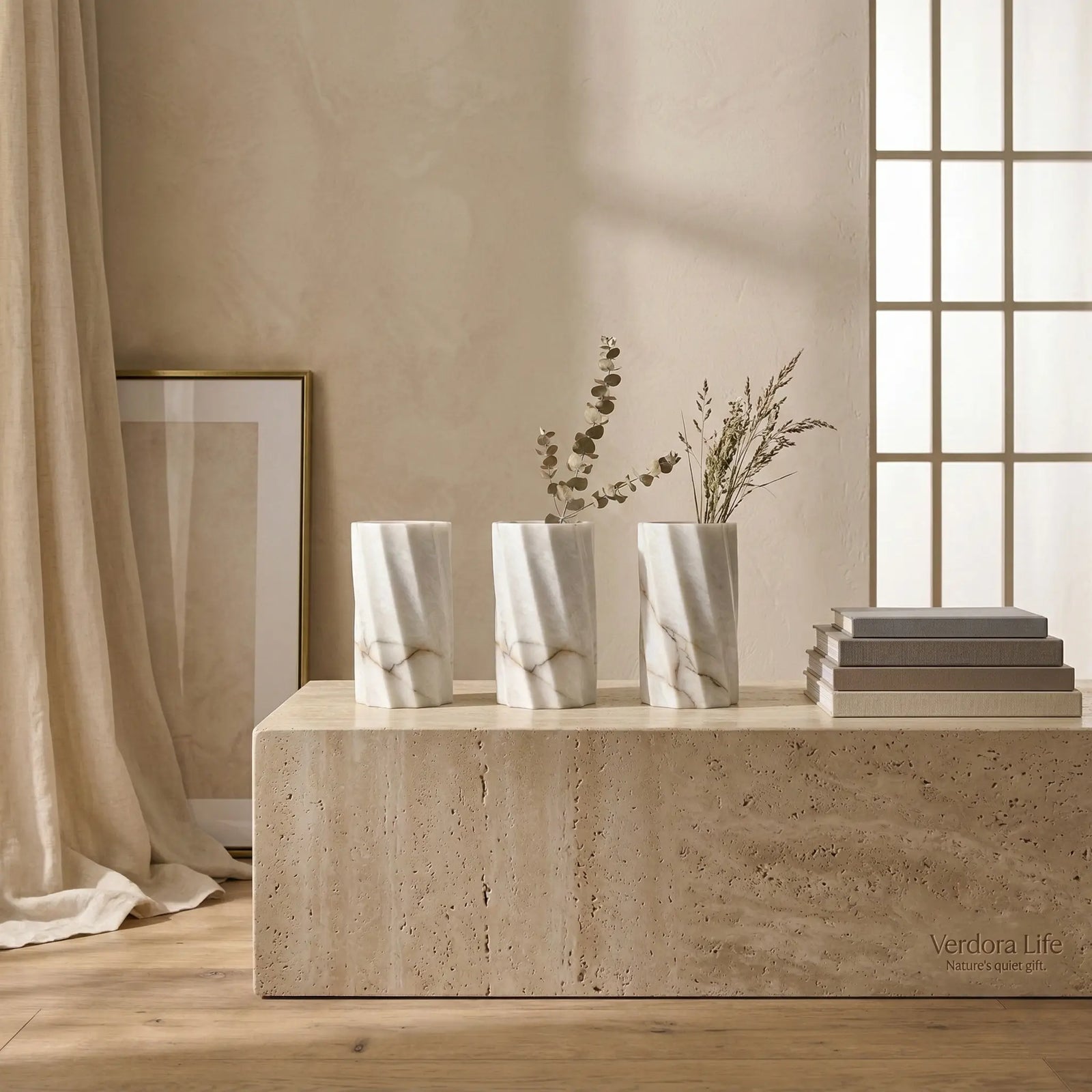 Trio set of Cylindrical Monolith Vases in various natural stones arranged on a minimalist stone pedestal.