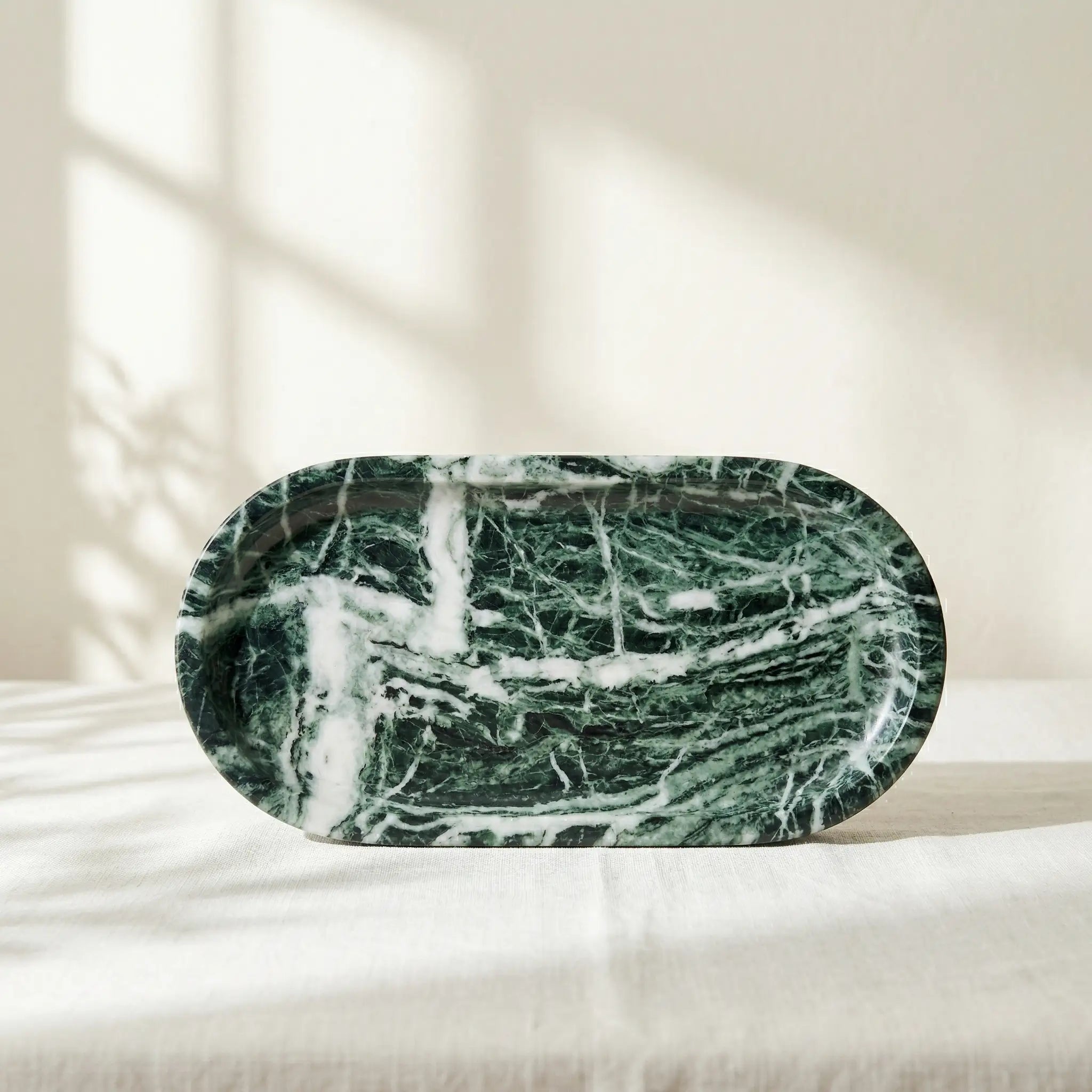 Emerald Plateau Stage oval tray handcrafted from luxury forest green marble with striking white veining.