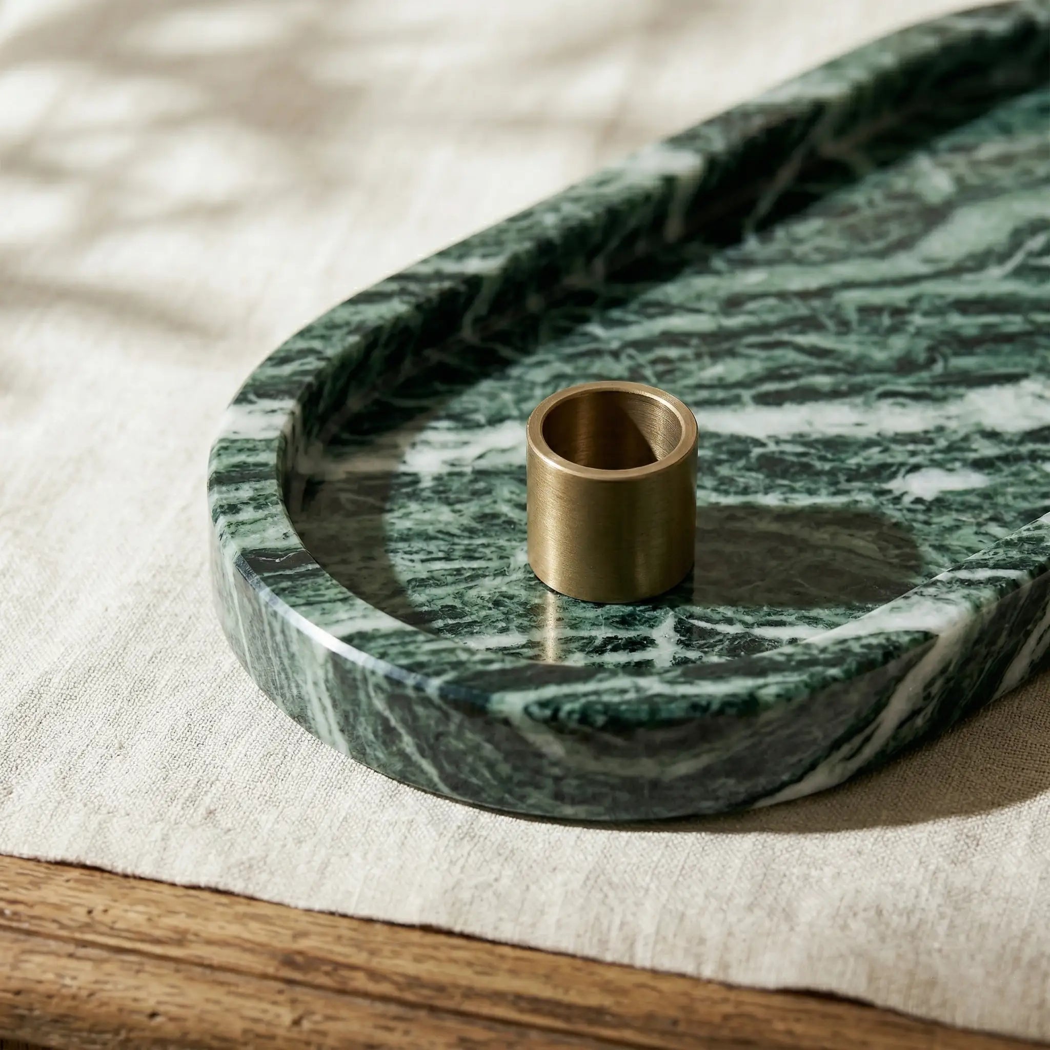 Close-up detail of Emerald Plateau Stage showing the rich green stone texture and polished rounded edges.