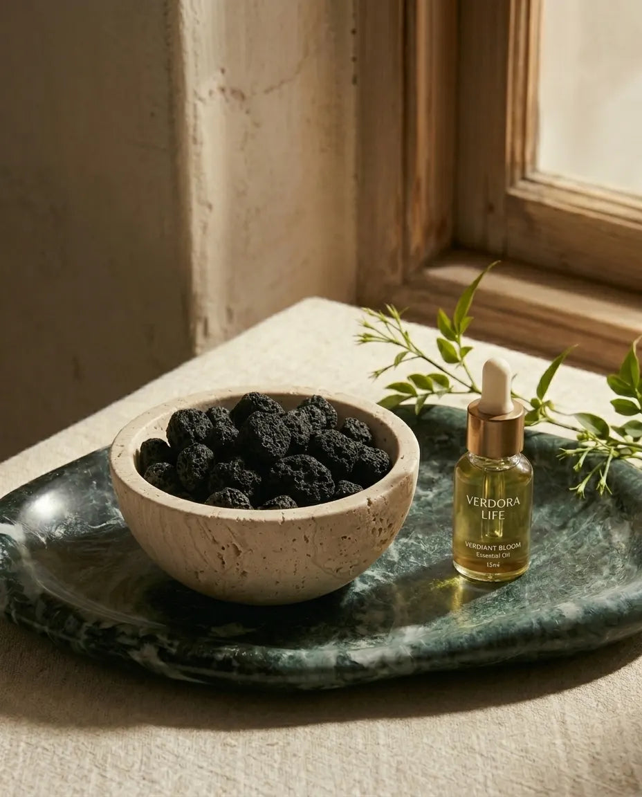 Close-up of a green marble bowl with volcanic lava stones and essential oils, part of the "Shop the Look" home fragrance collection.