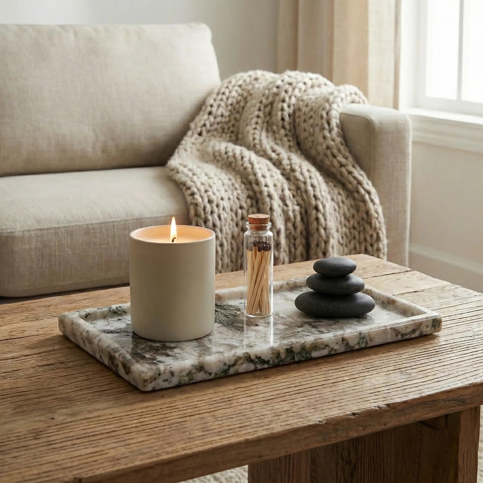Luxury Marble Oval Tray on a coffee table with a candle and stones for a relaxing lifestyle scene