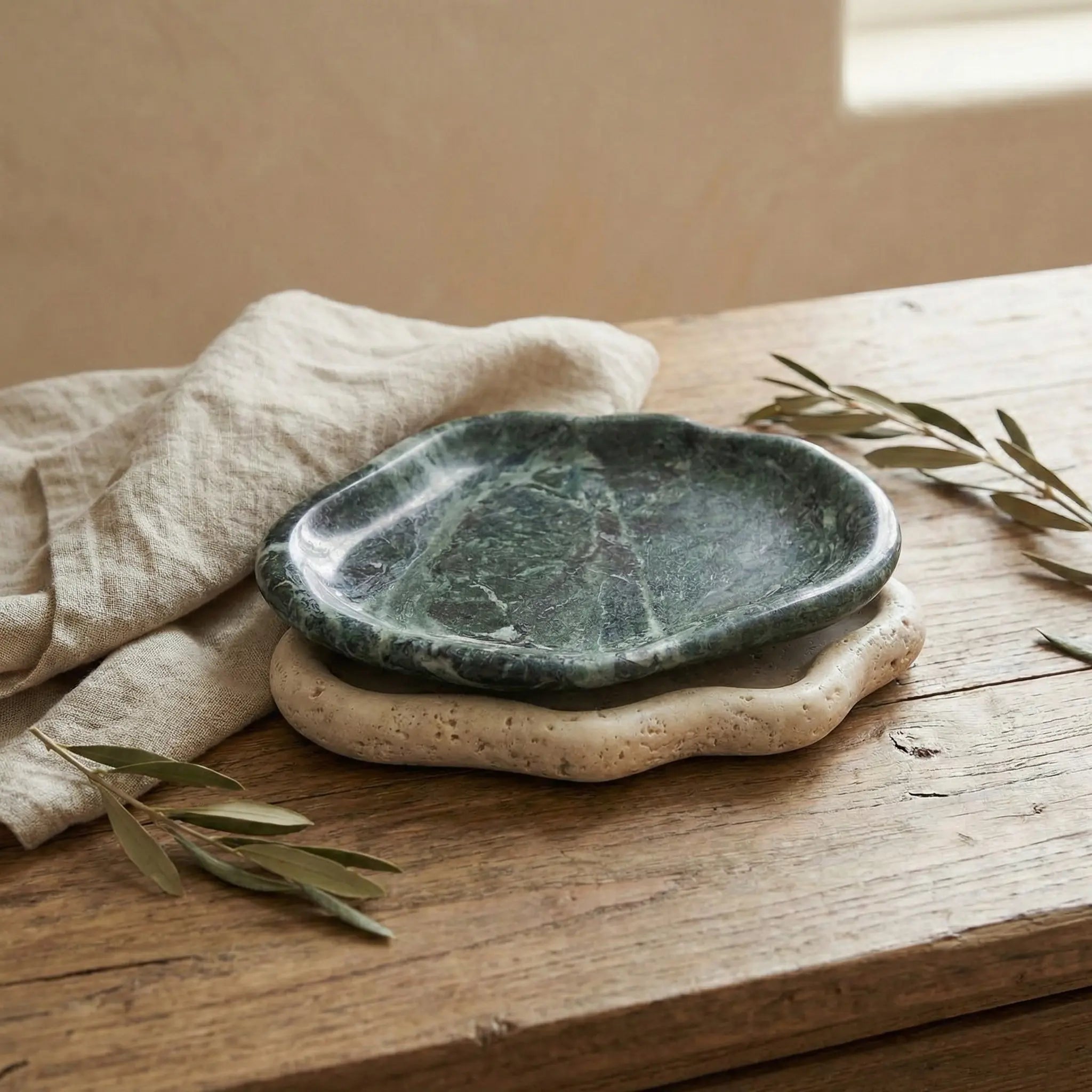 Two Marble Cloud Trays in different natural stones stacked to show organic shape and texture contrast