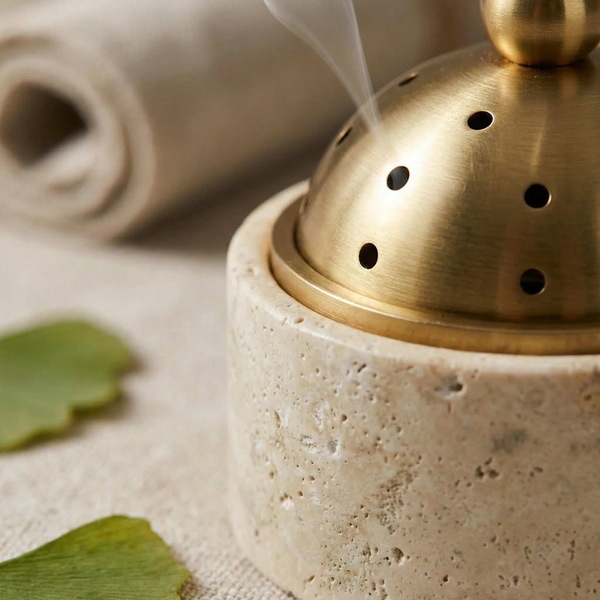 Detailed macro shot of Metallic Core Censer showing porous travertine stone texture