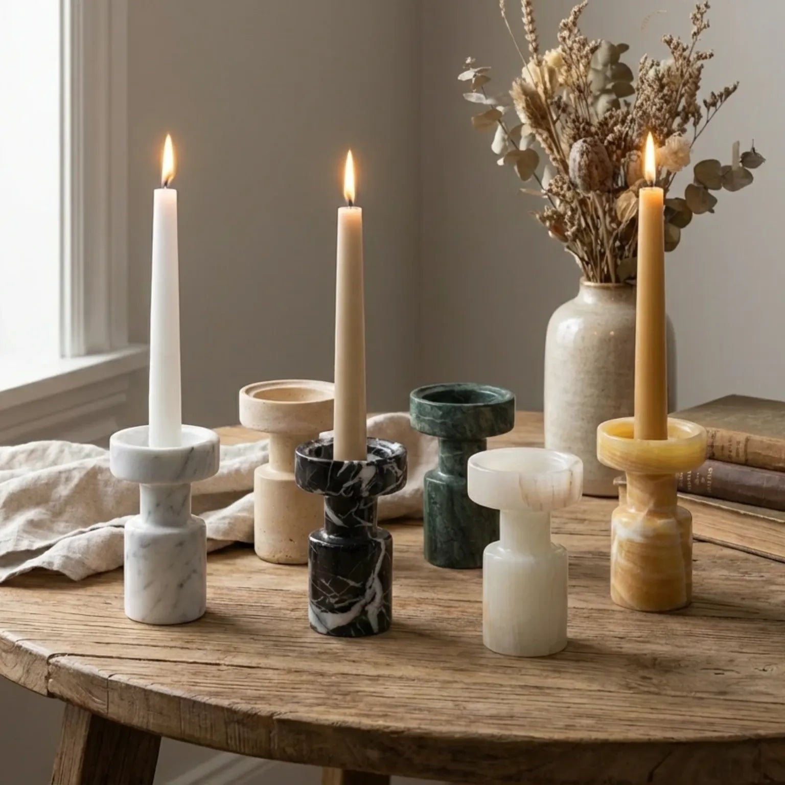Minimalist Marble Holders with burning taper candles on a wooden table in a cozy home setting