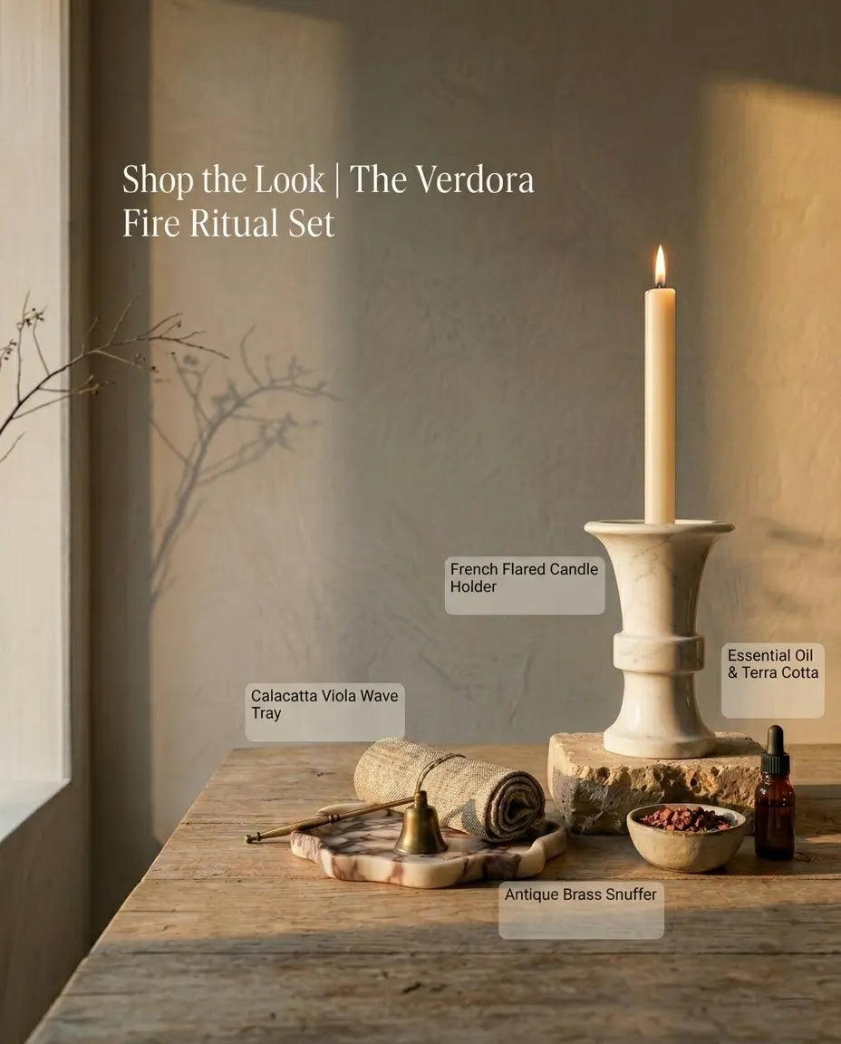"Shop the Look" scene showing a Brass Monolith candlestick and marble accessories arranged on an elegant wooden console table.