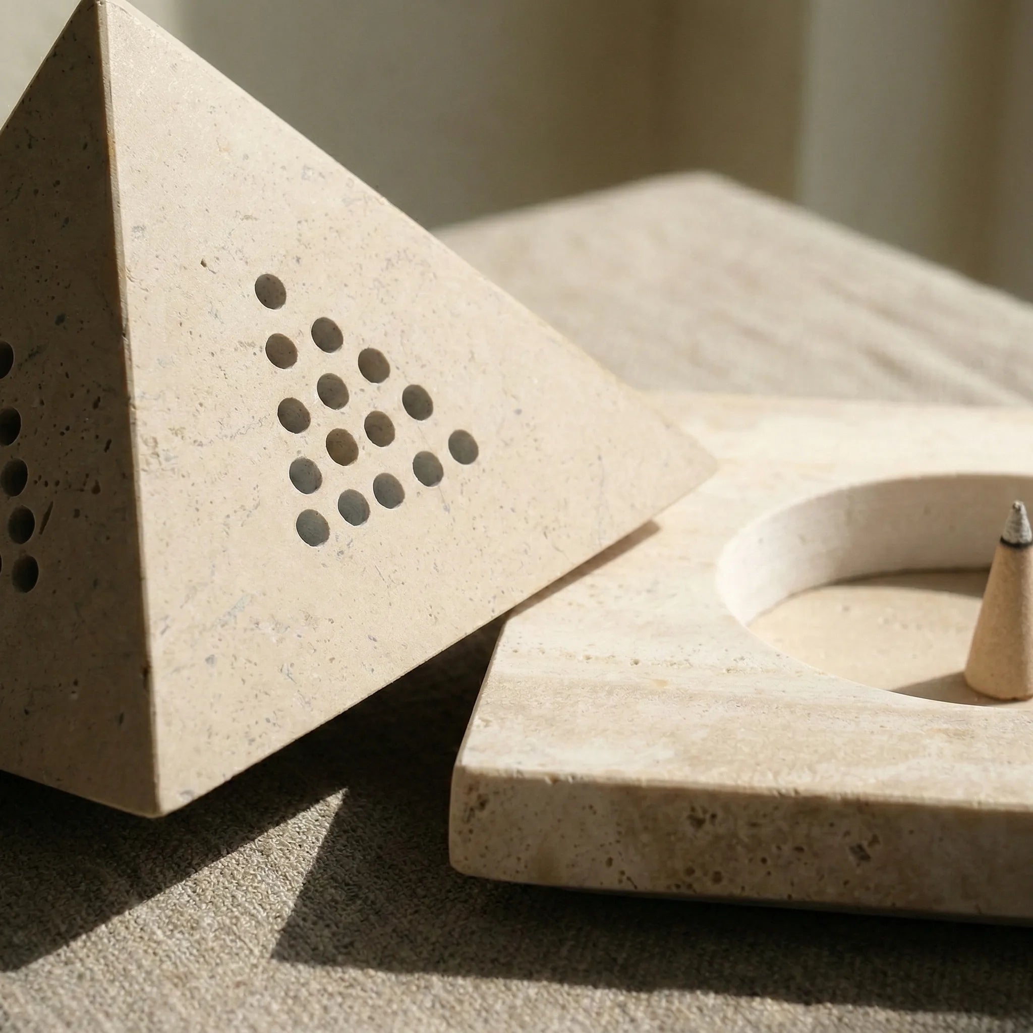 Macro shot of Travertine Core Basin showing natural beige stone texture and geometric pyramid design