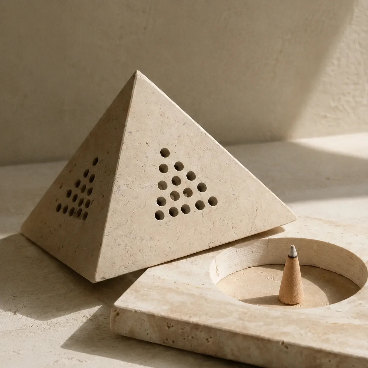 Close-up detail of natural travertine texture and handcrafted stone incense holder surface