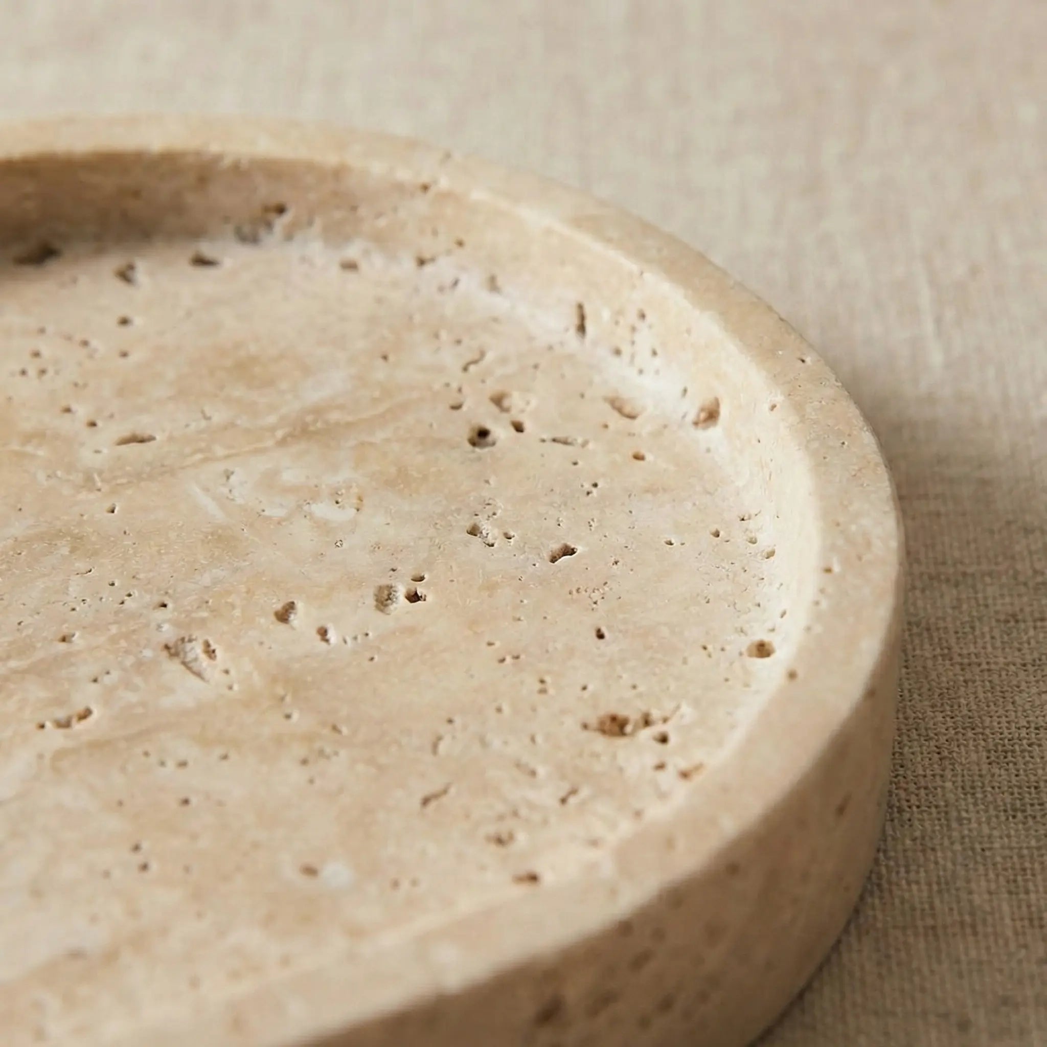 Close-up detail of Travertine Oval Platter showing natural pitted stone texture
