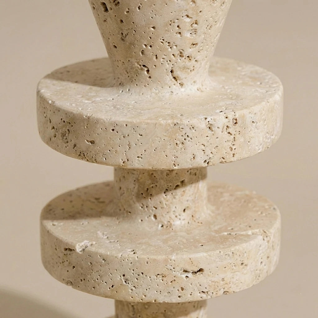 Macro shot of Travertine Tower Holder highlighting the natural beige stone texture and geometric rings