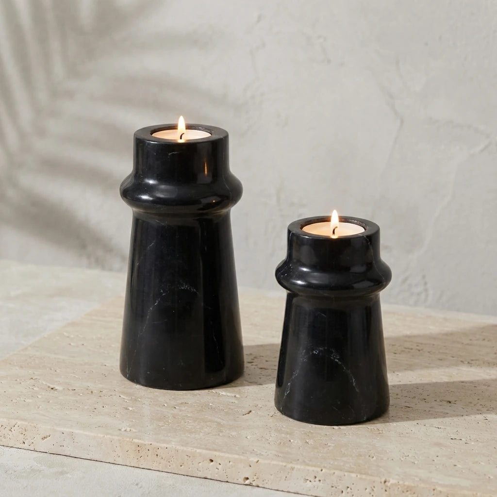 Black Marble Taper Holders with burning candles in a minimalist lifestyle setting