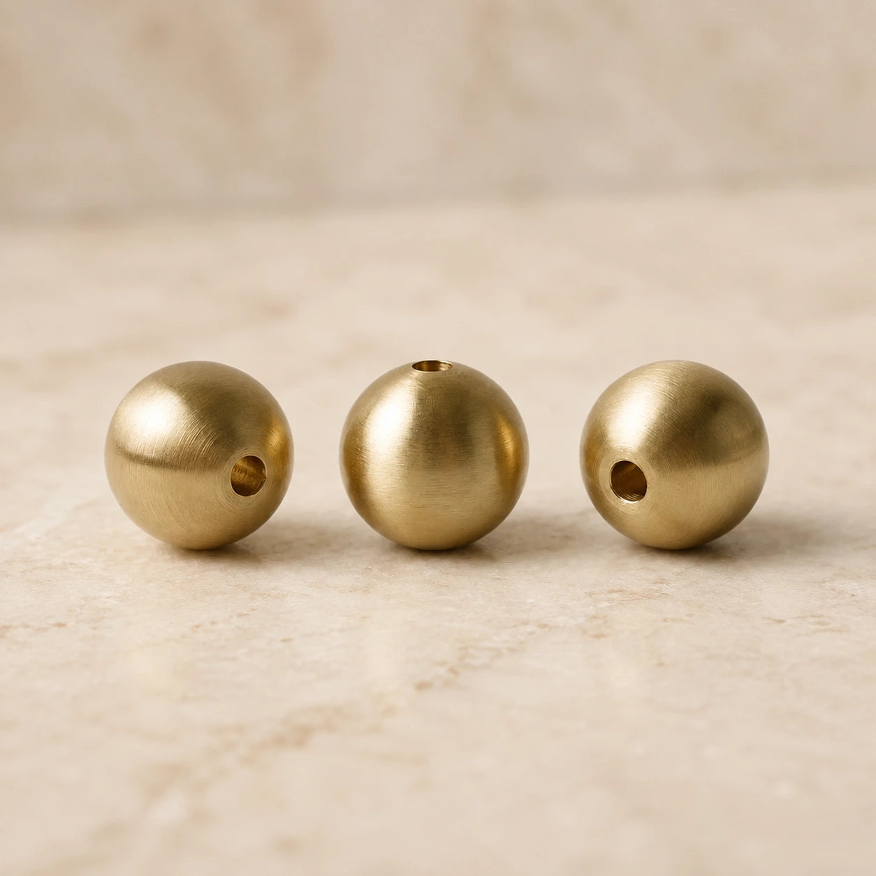 Close-up detail of brushed brass incense vessel components with a warm golden metal finish