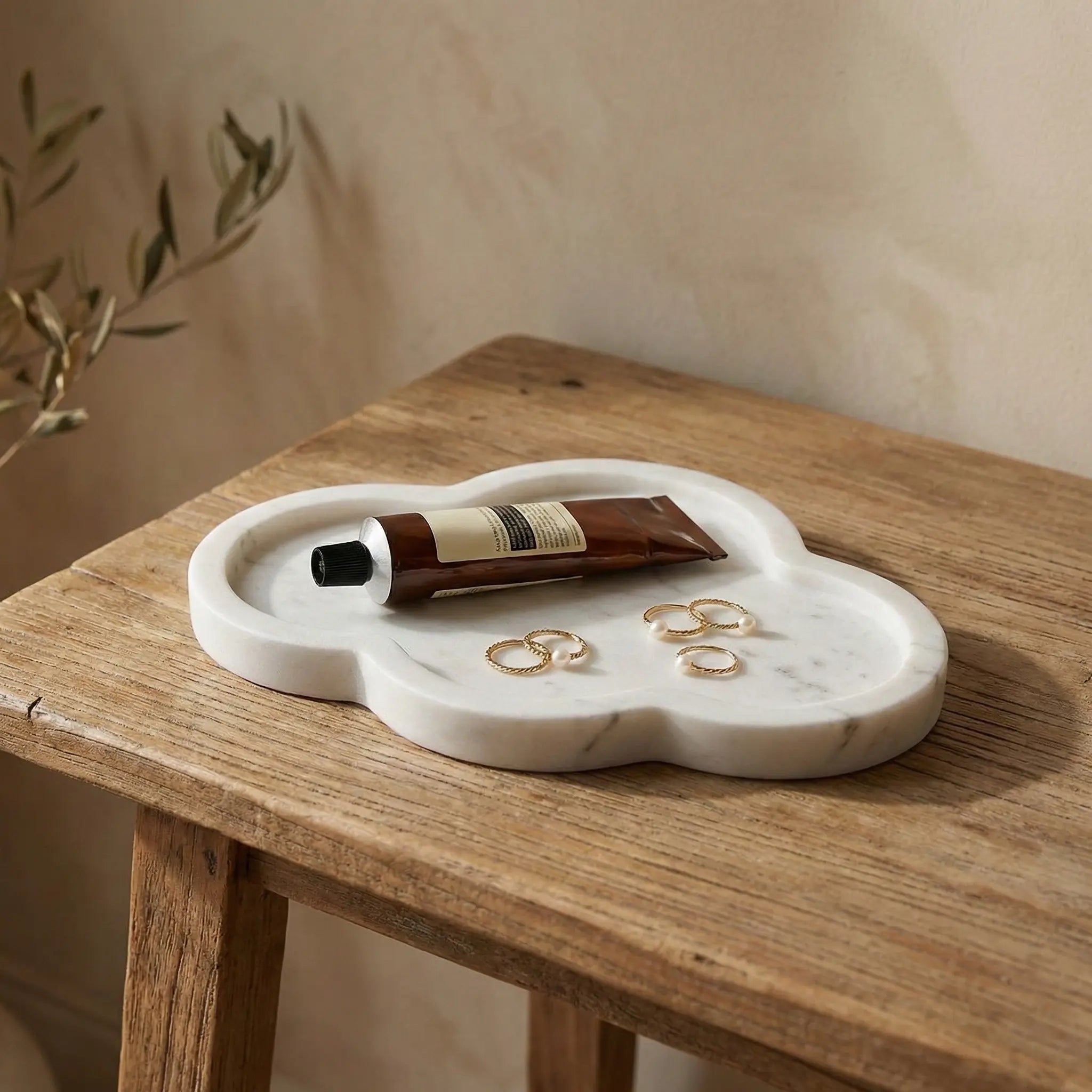 Calacatta White Cloud Tray used as a luxury jewelry and accessory organizer on a rustic wooden tabletop.