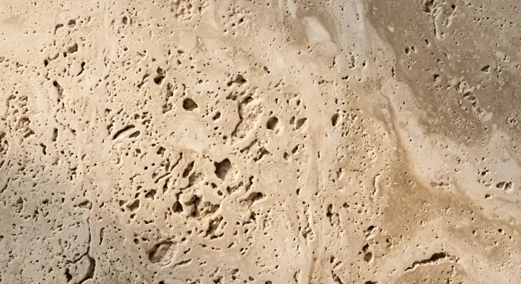 Natural beige travertine stone texture highlighting the characteristic organic porous and pitted surface.