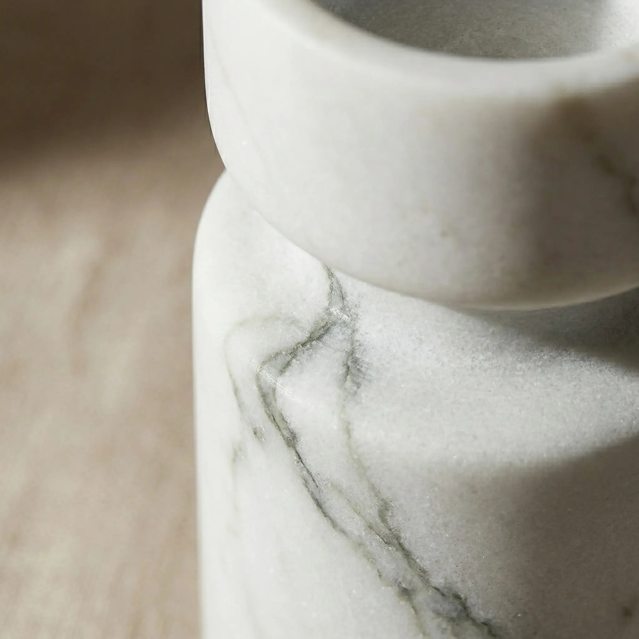 Macro shot of Cylindrical Monolith Pillar showing natural white stone texture and veins