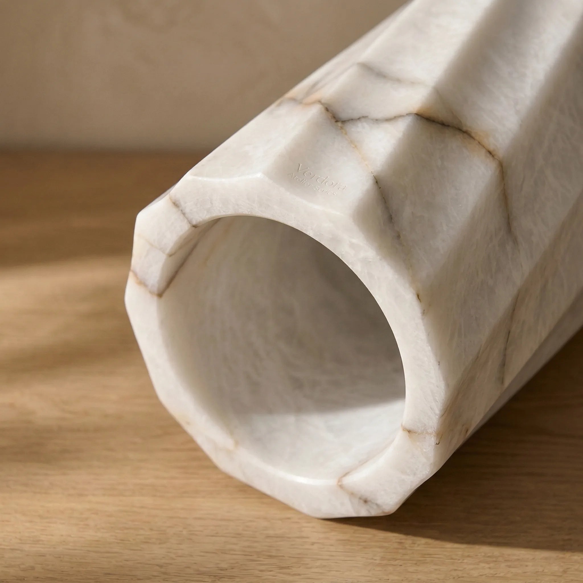 Top down view of Cylindrical Monolith Vase highlighting the hollow center and natural marble mineral veining.