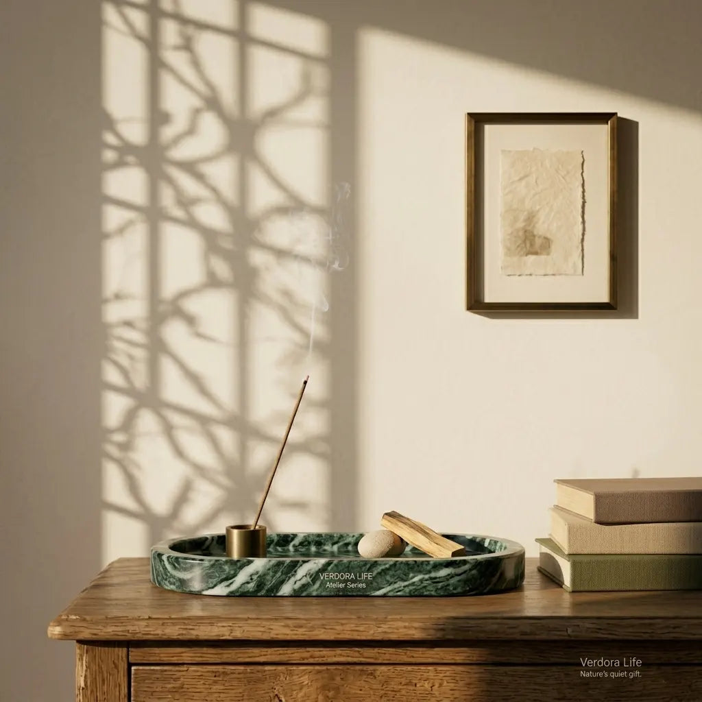 Emerald Plateau Stage green marble tray styled on a vintage wooden desk with books and artistic shadows.