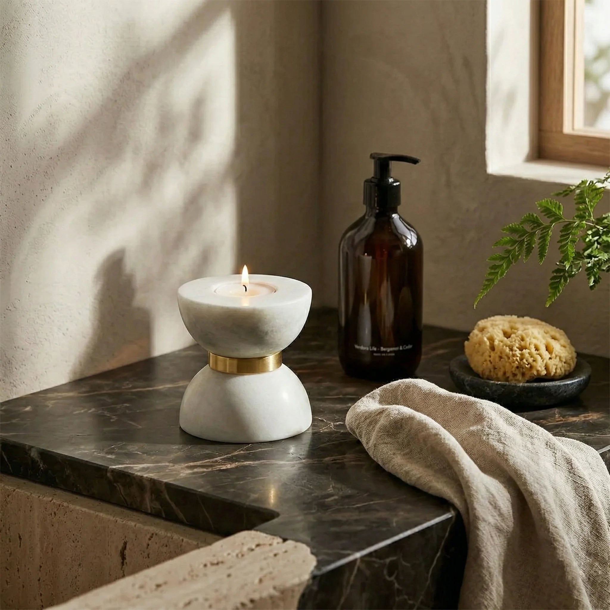 Funnel Monolith Pillar white stone candle holder in a luxury bathroom decor arrangement