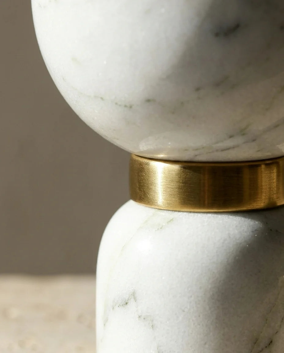 Detailed shot of Funnel Monolith Pillar showing the brass ring and smooth marble stone curves