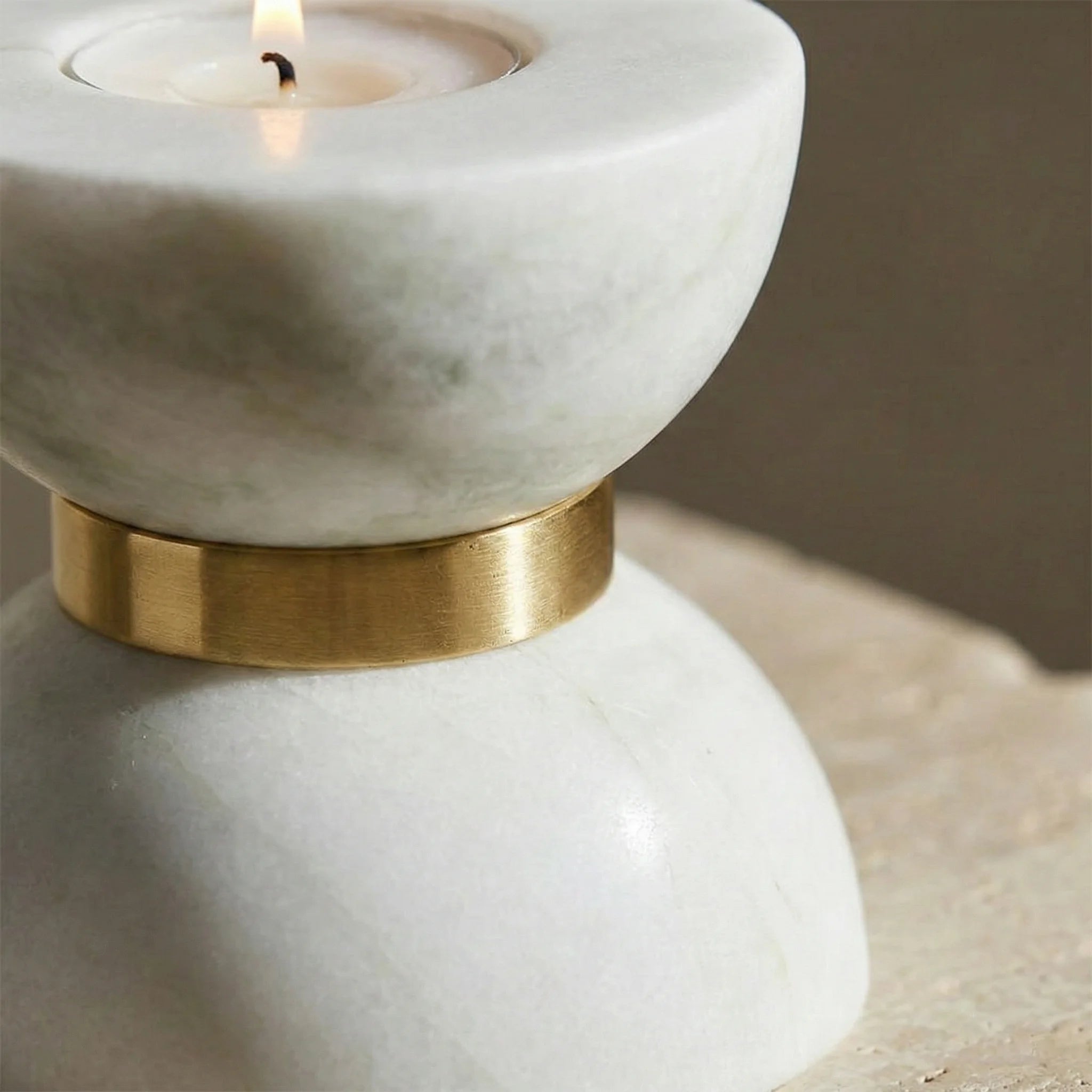 Detailed macro zoom of Funnel Monolith Pillar showing the polished stone texture and brass metal inlay