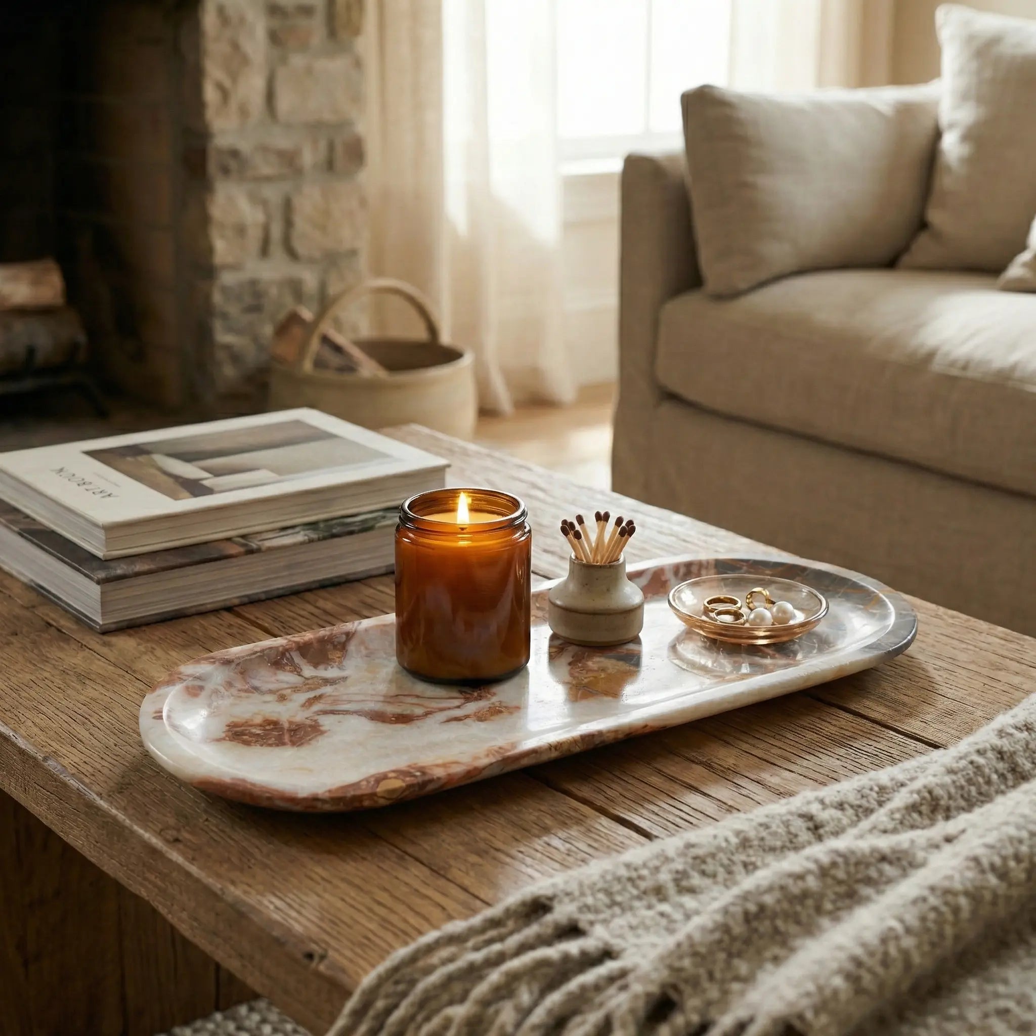 Grand Marble Gallery Tray with a burning candle on a coffee table in a cozy living room setting