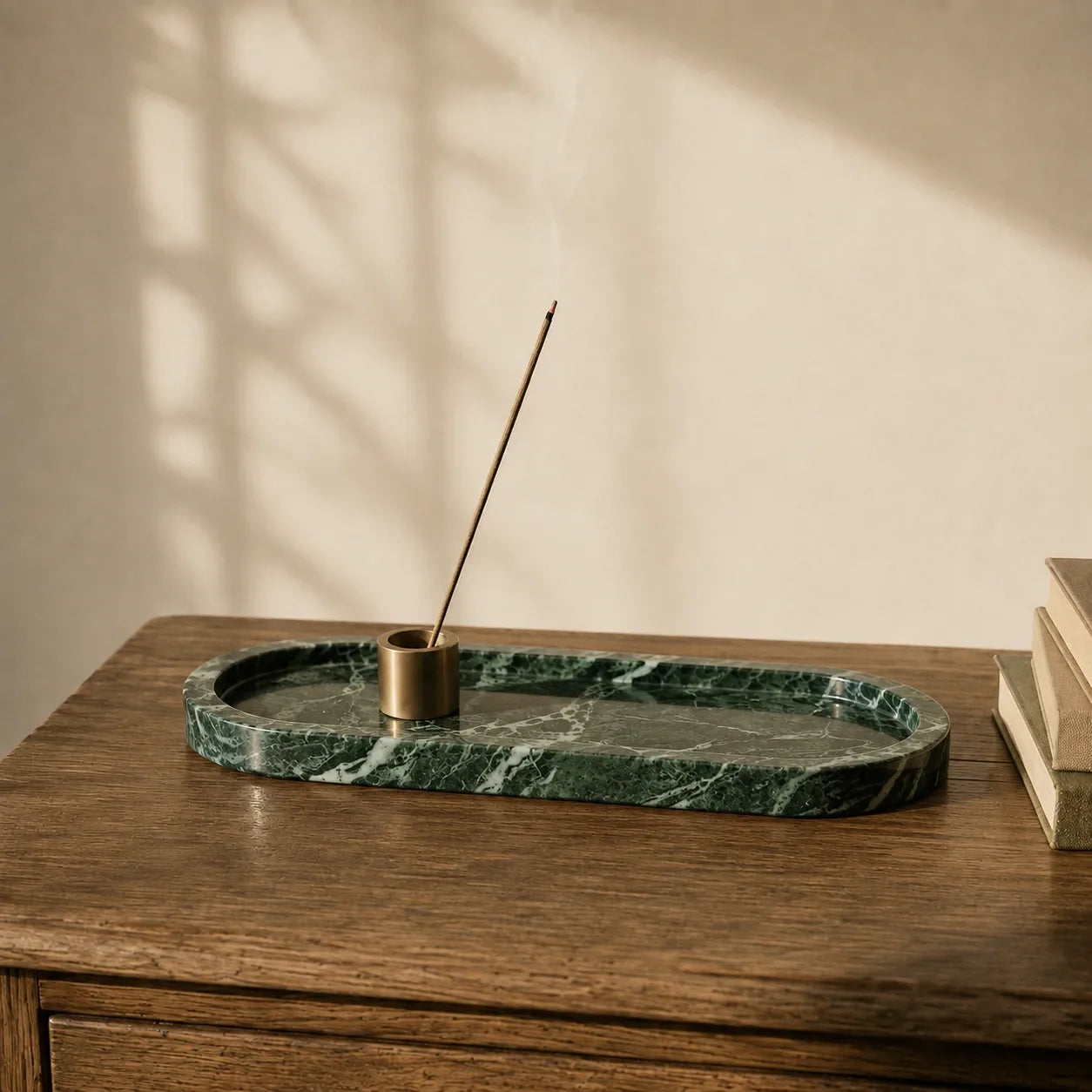 Green marble tray with brass incense holder on a walnut table, showcasing natural stone veining and a minimalist incense ritual setting.