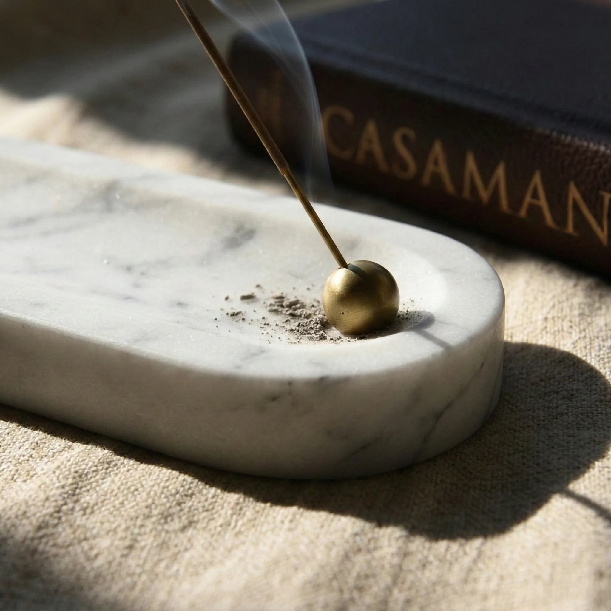 Linear Monolith Relic white stone incense burner in a minimalist home decor setting
