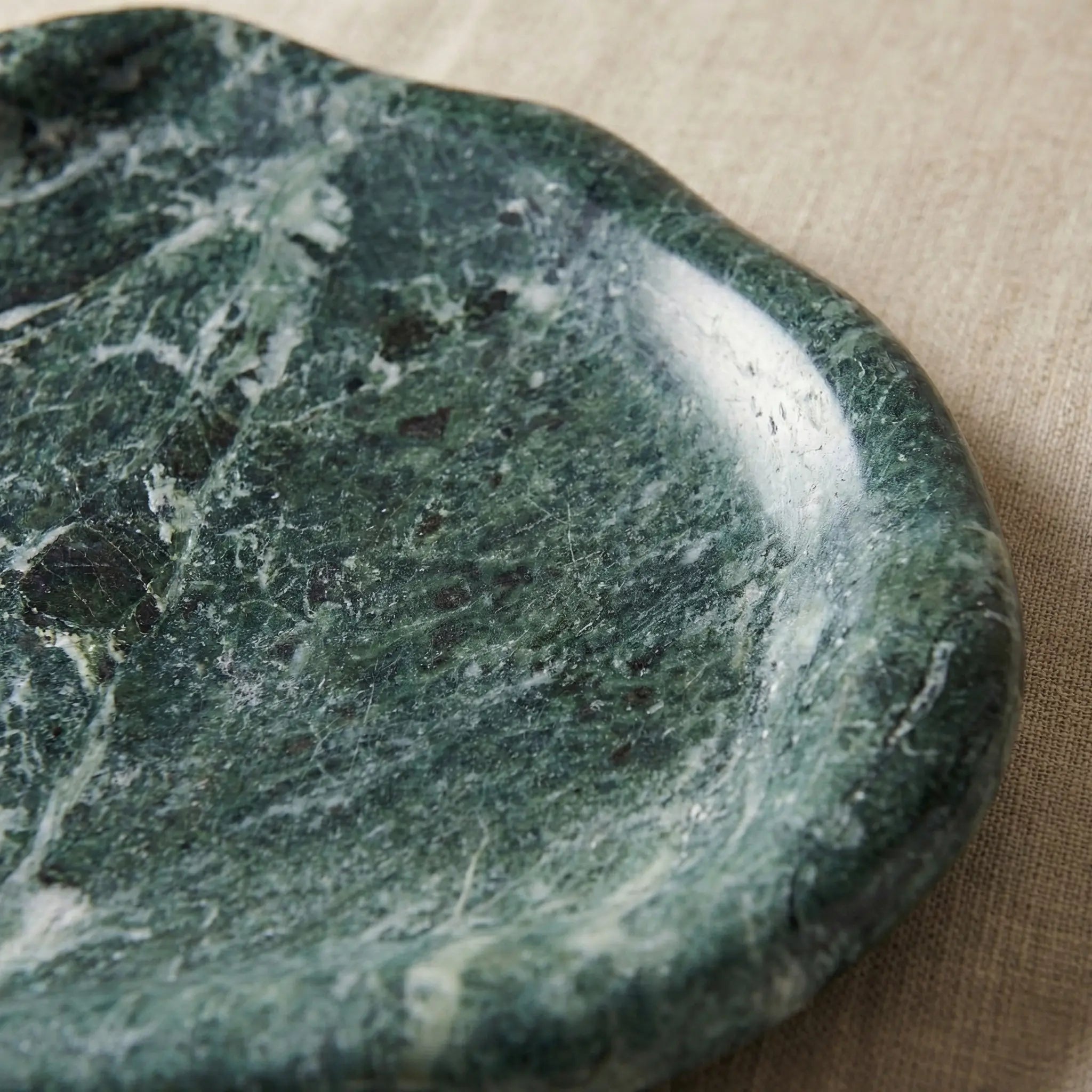 Detailed view of Marble Cloud Tray showing the rich green stone patterns and curved edge craftsmanship