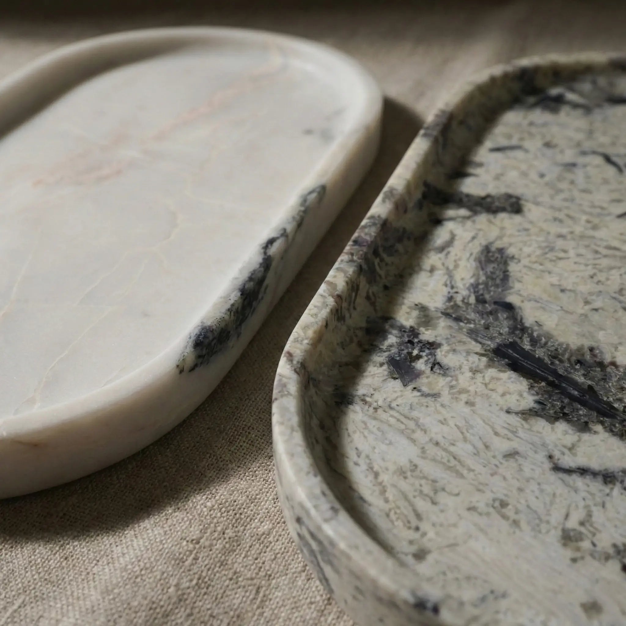 Marble Oval Trays used for coffee and jewelry organization on a dark wooden tabletop