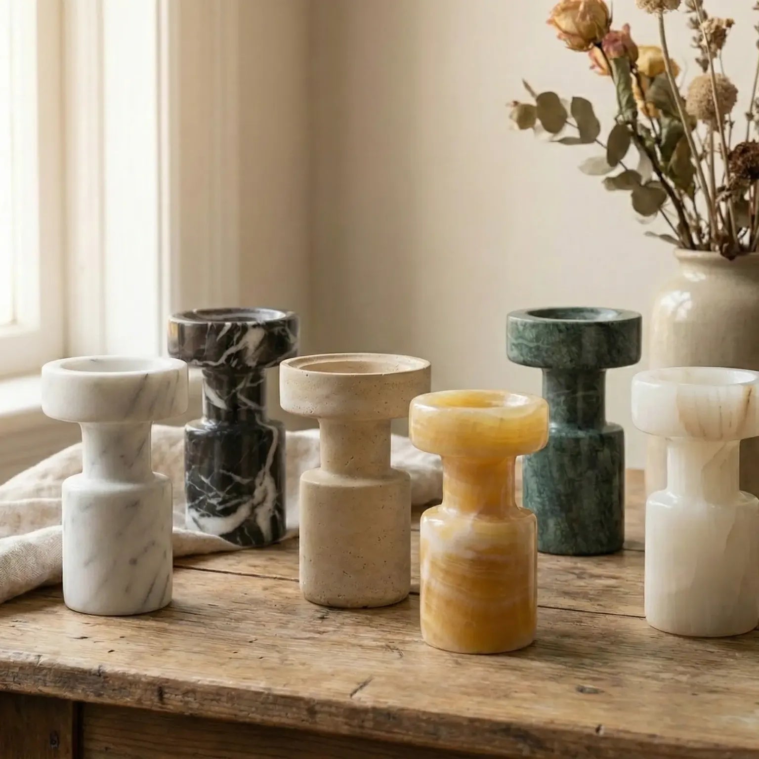 Collection of Minimalist Marble Holders displayed as sculptural stone decor on a sunlit wooden desk
