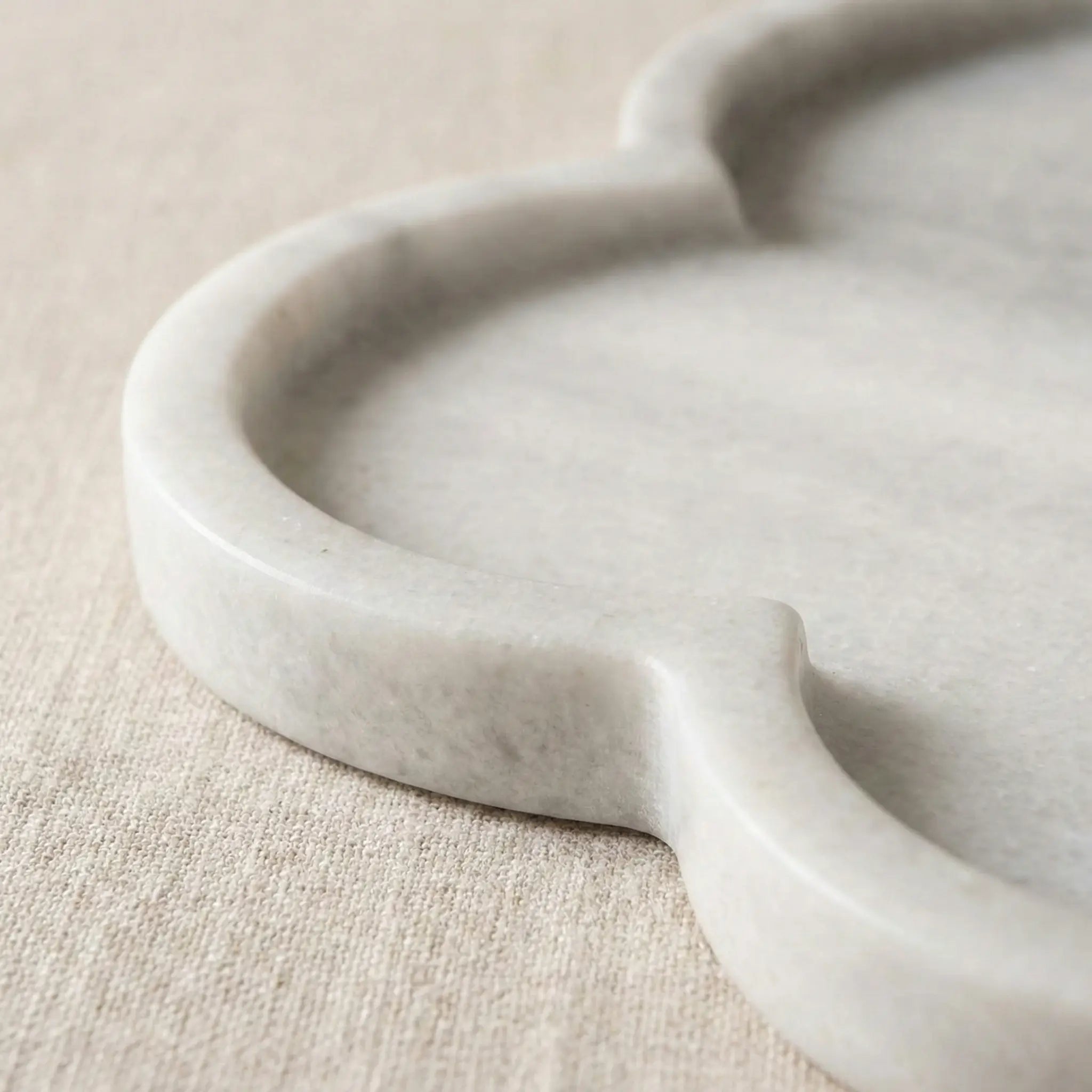 Close-up of Petal Marble Platter highlighting the smooth floral five-edge stone carving