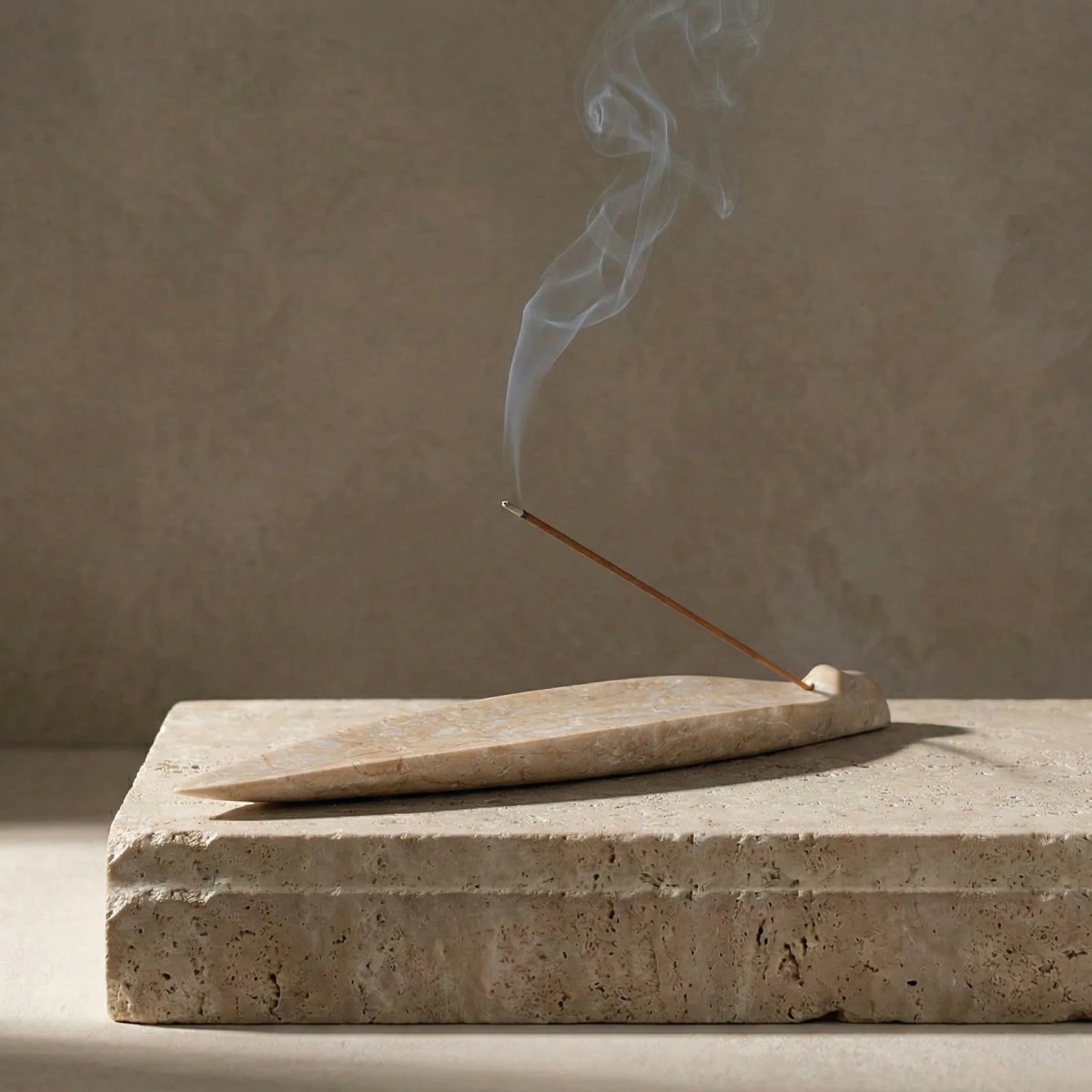 Petrified Leaf Relic beige stone incense holder on a rustic base with smoke lifestyle