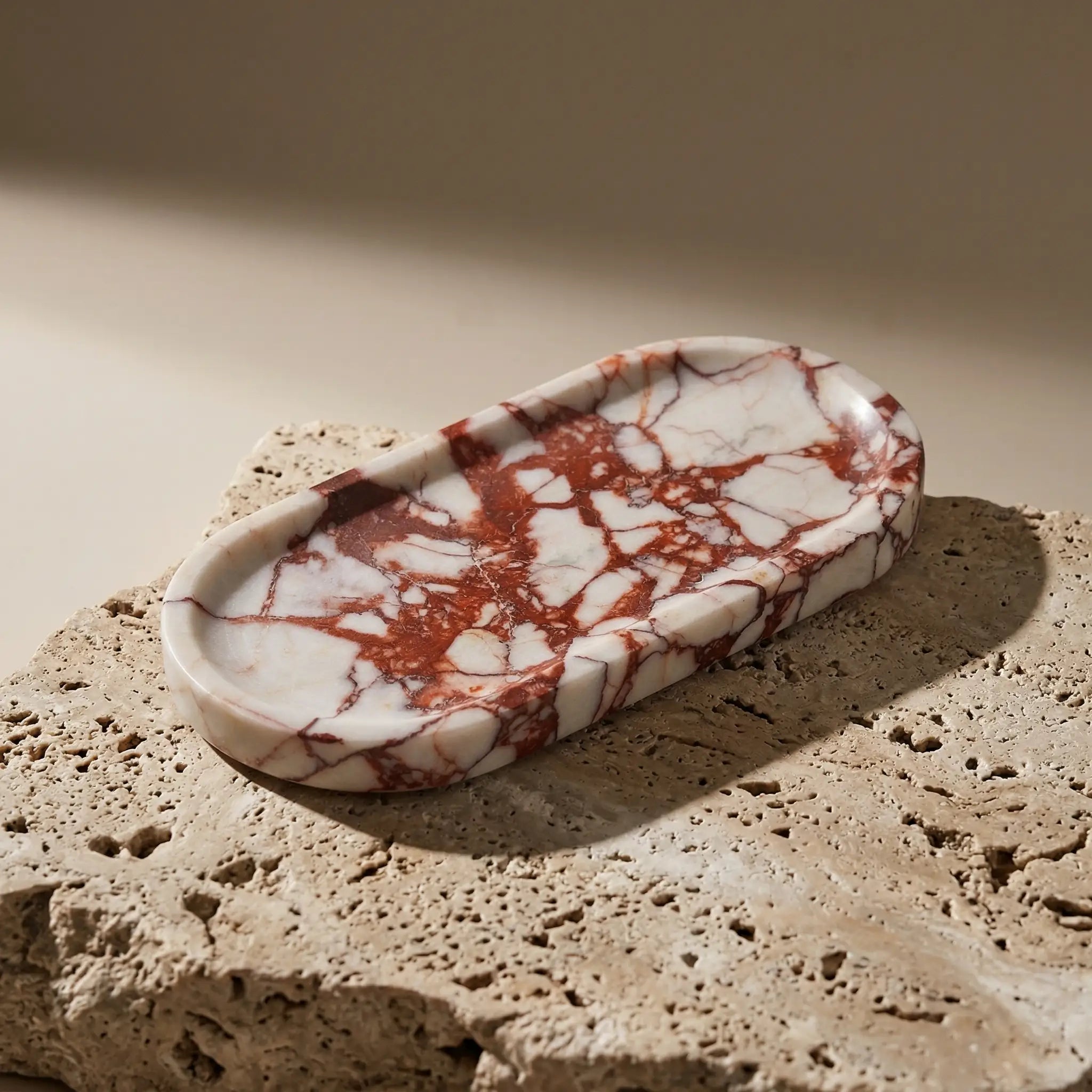 Sangria Plateau Stage handcrafted from luxury red and white veined marble stone on a natural travertine block.