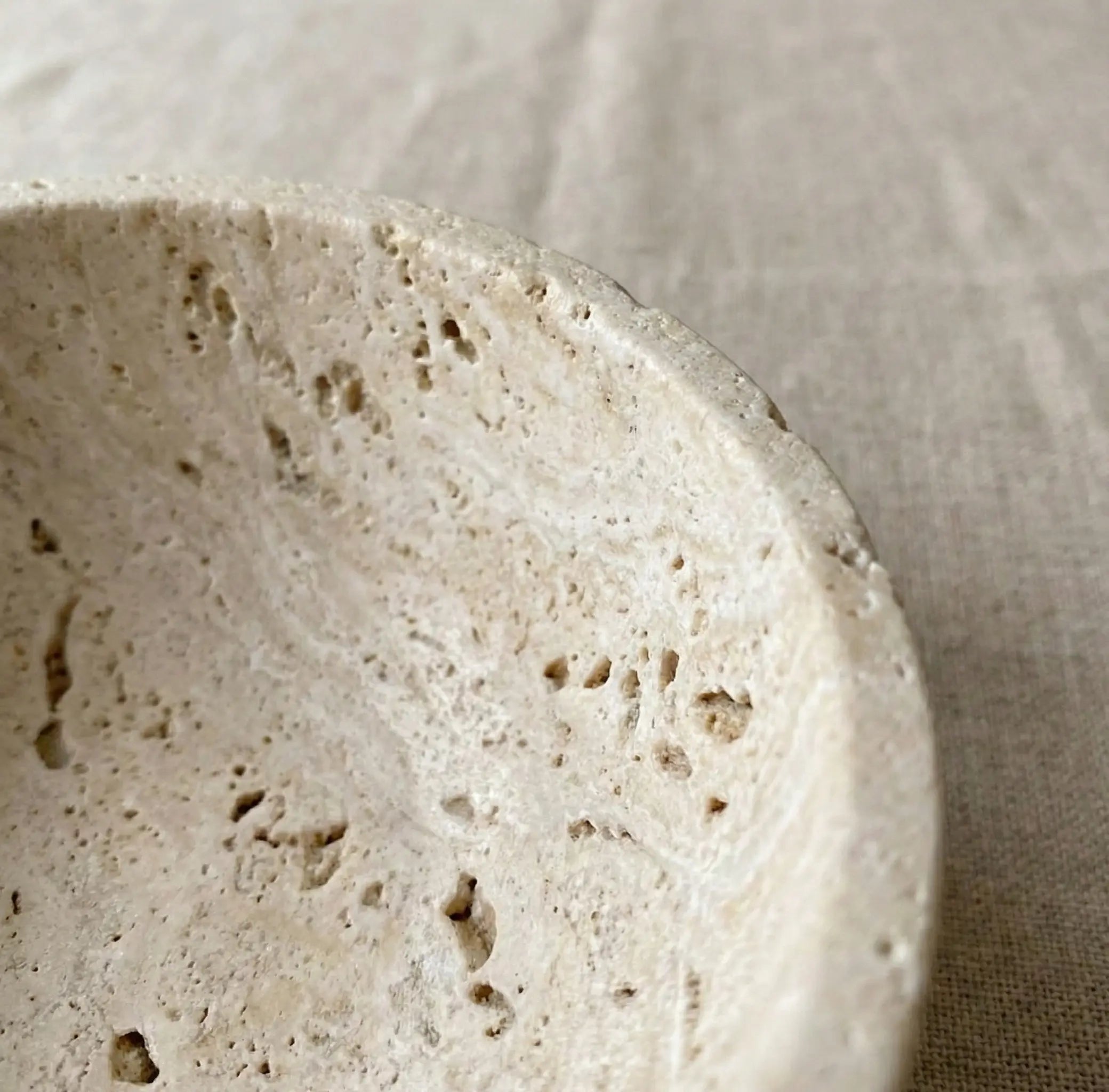 Macro zoom of Travertine Chalice Bowl highlighting the organic pitted stone surface and earth tones