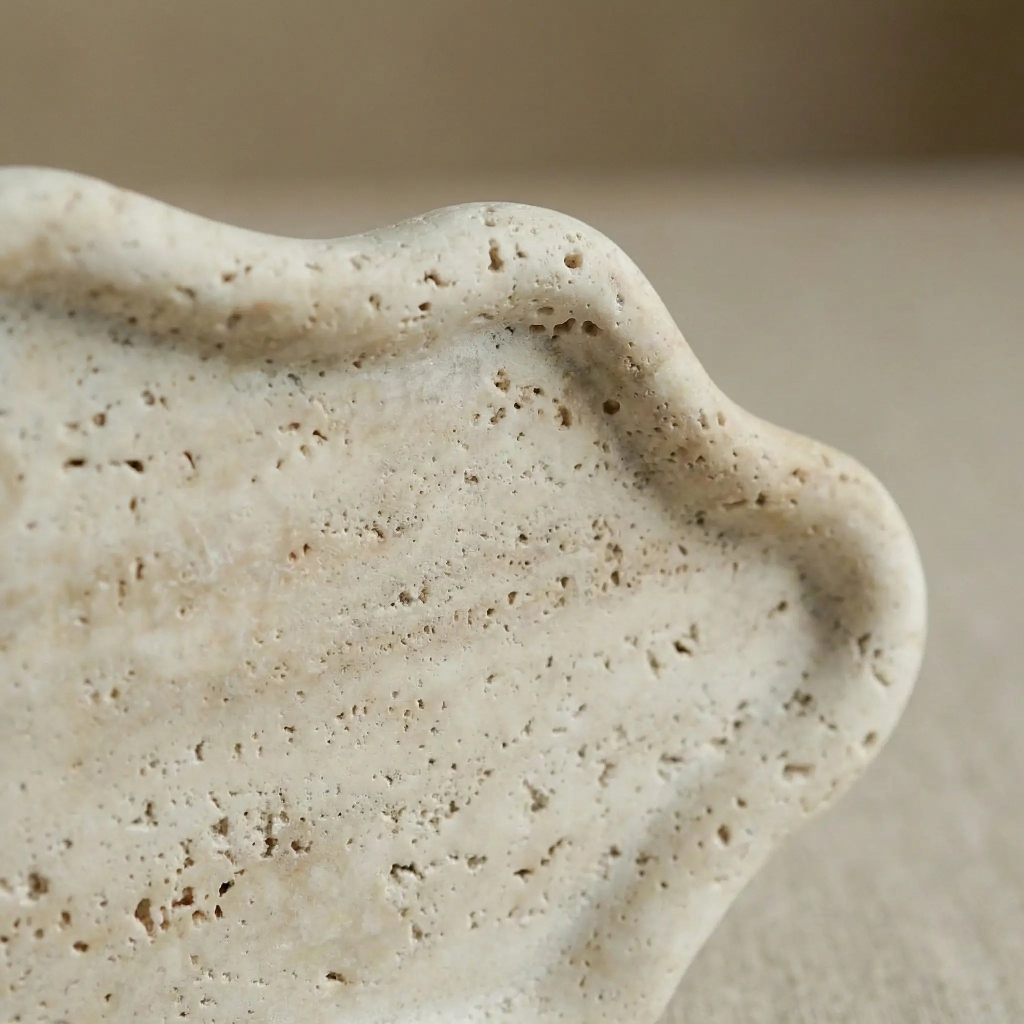 Detailed macro shot of Travertine Cloud Tray highlighting the natural porous and pitted stone texture