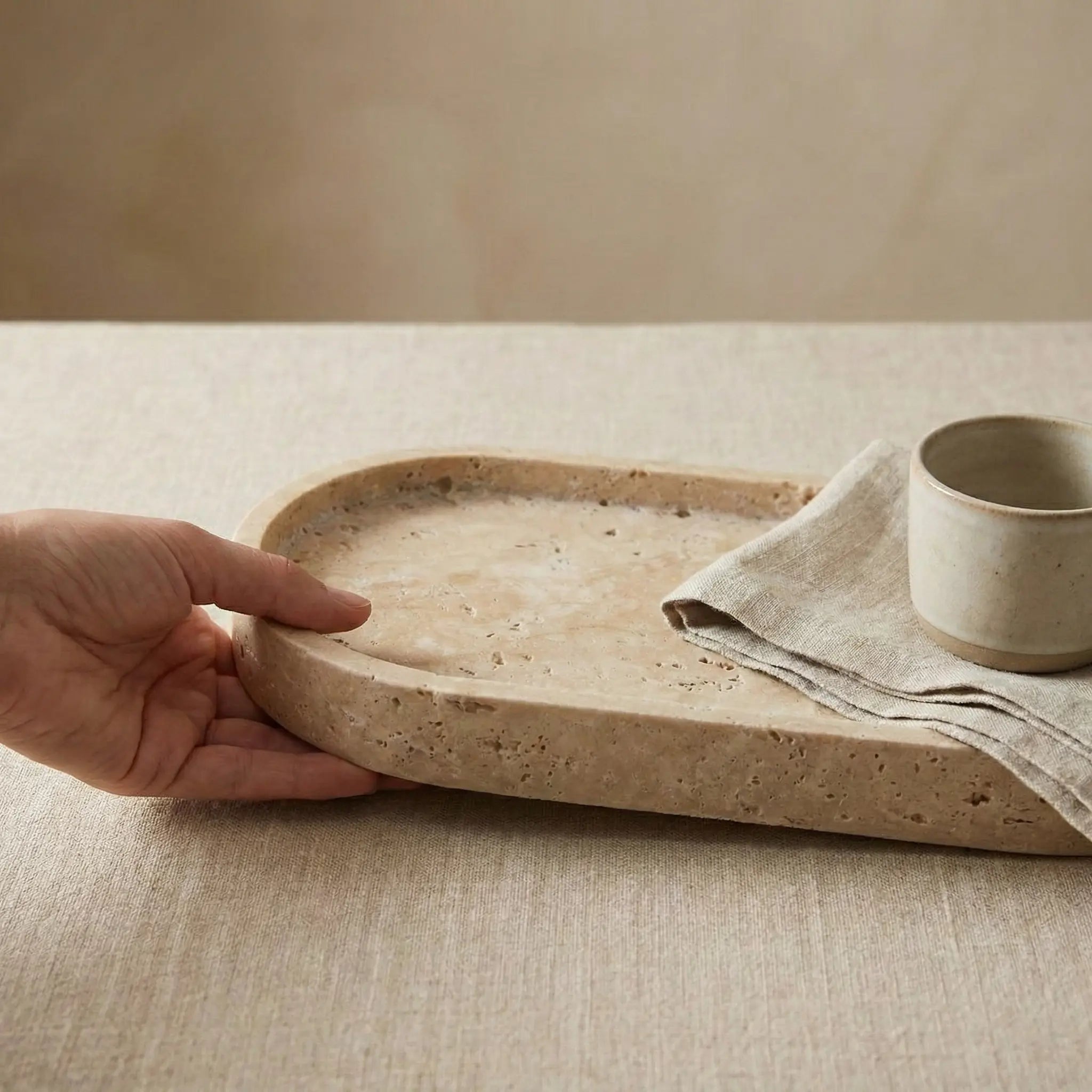 Travertine Oval Platter size comparison held in hand showing dimensions
