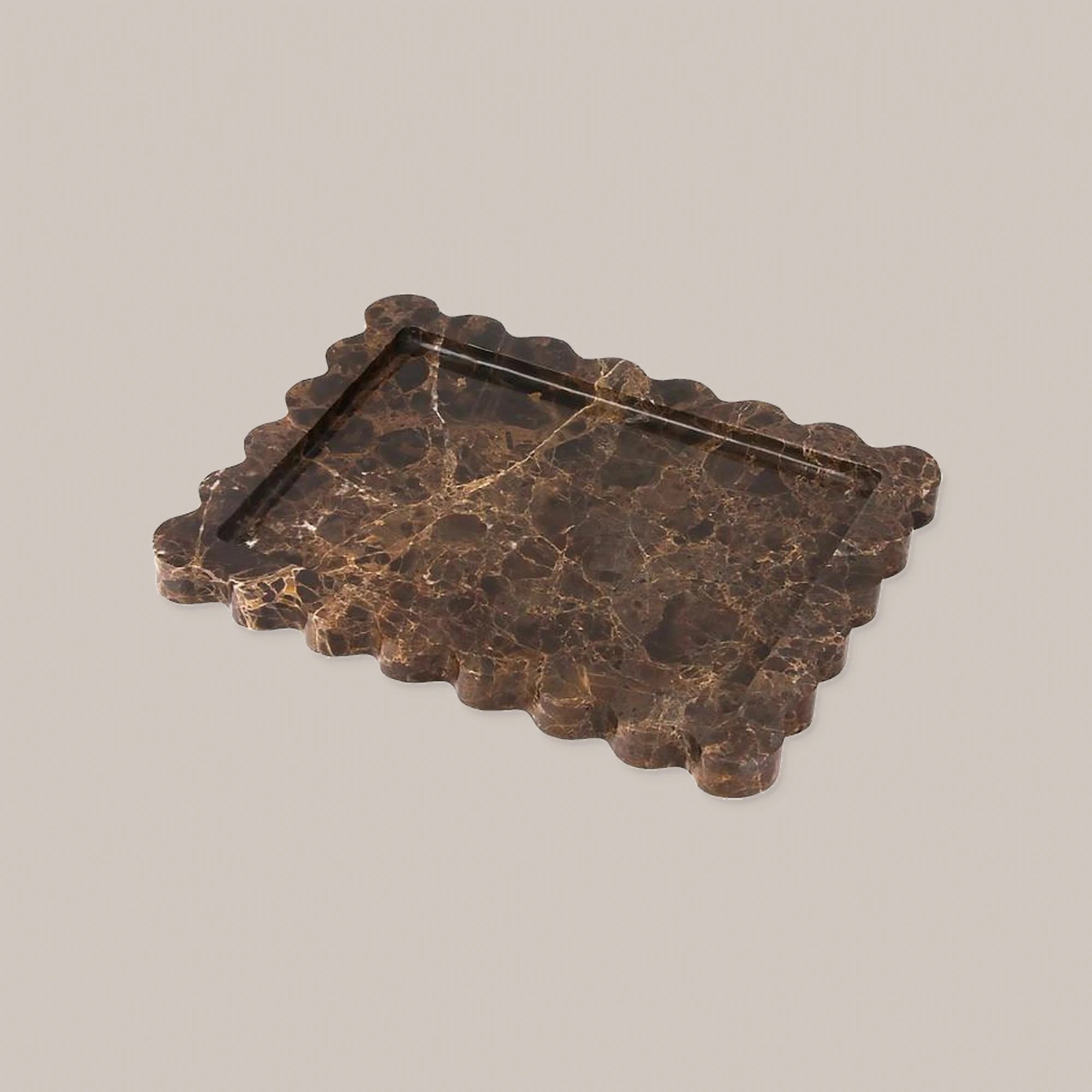 Dark chocolate brown rectangular scalloped marble tray on a warm neutral background