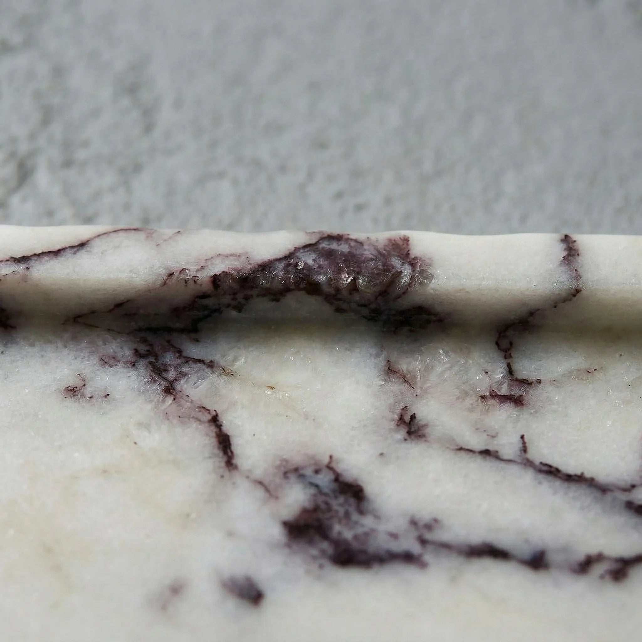 Macro shot of Viola marble stone texture highlighting purple and white veins